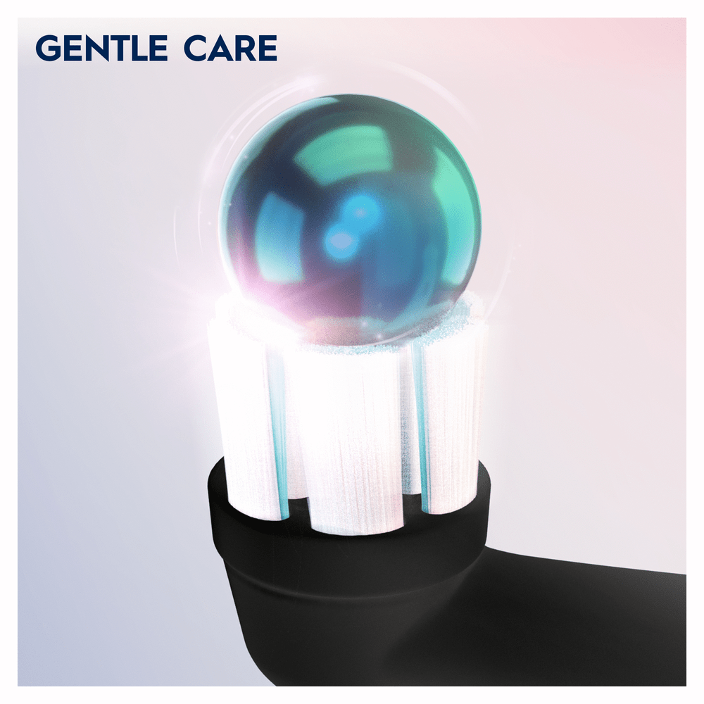 Primer plano de un cabezal de cepillo de dientes con un orbe azul y verde encima. Fondo rosa.
