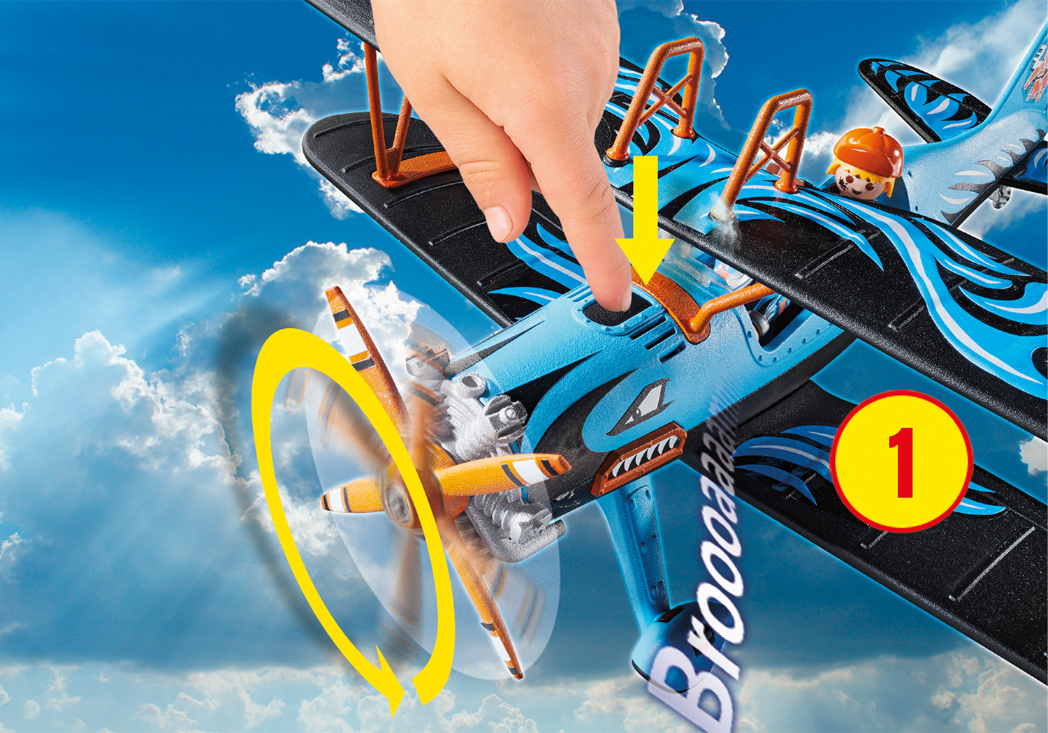 Spielzeugflugzeug mit einer Person, die auf ein Teil zeigt.