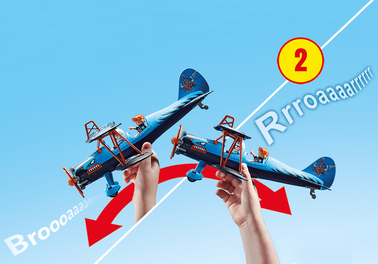 Zwei Spielzeug-Doppeldecker, die von Händen gehalten werden, mit Grafiken der Soundeffekte am Himmel.