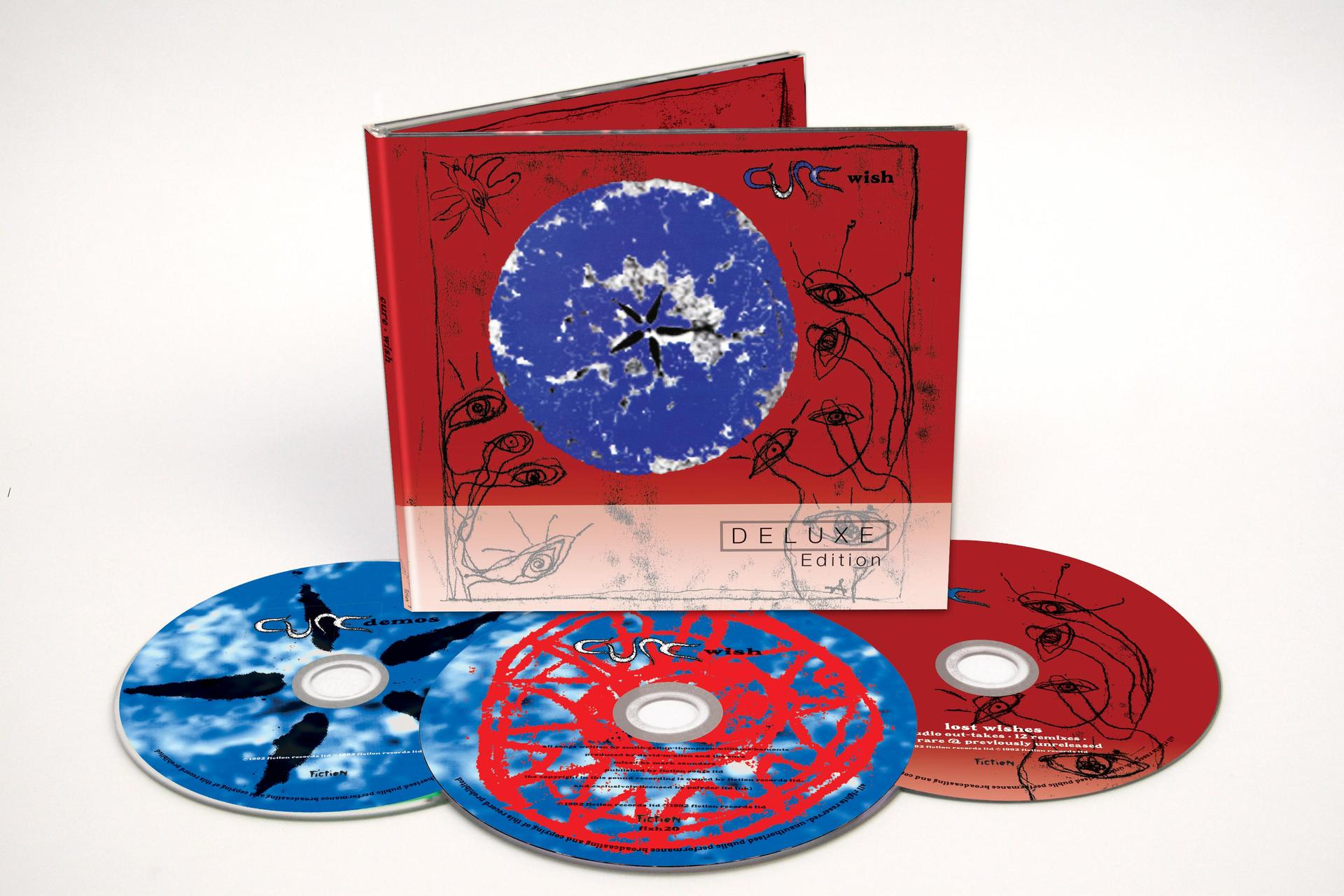 CD-Set für The Cures Album 'Wish'. Drei CDs und ein Booklet im Vordergrund.