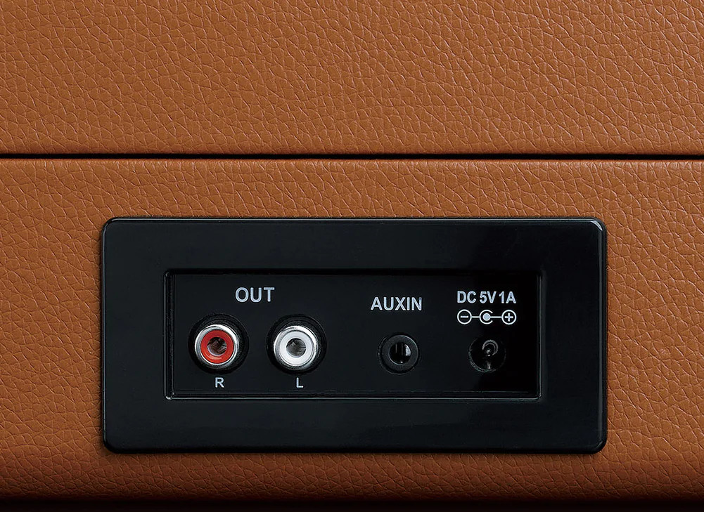 Close-up of a turntable's audio output and aux ports.