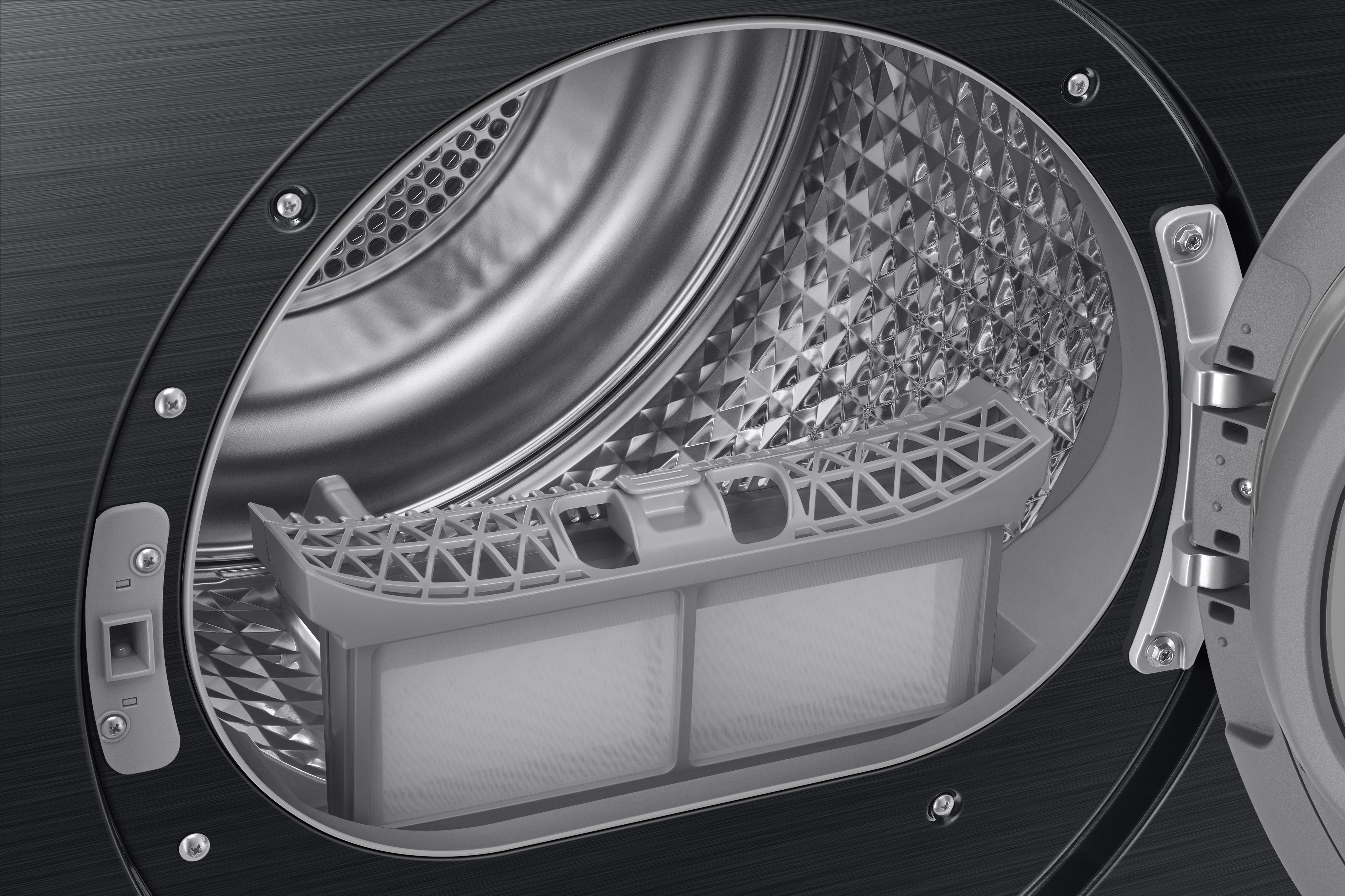Gros plan sur l'intérieur d'une machine à laver. Un filtre est visible. Couleurs gris foncé et argent métallique.