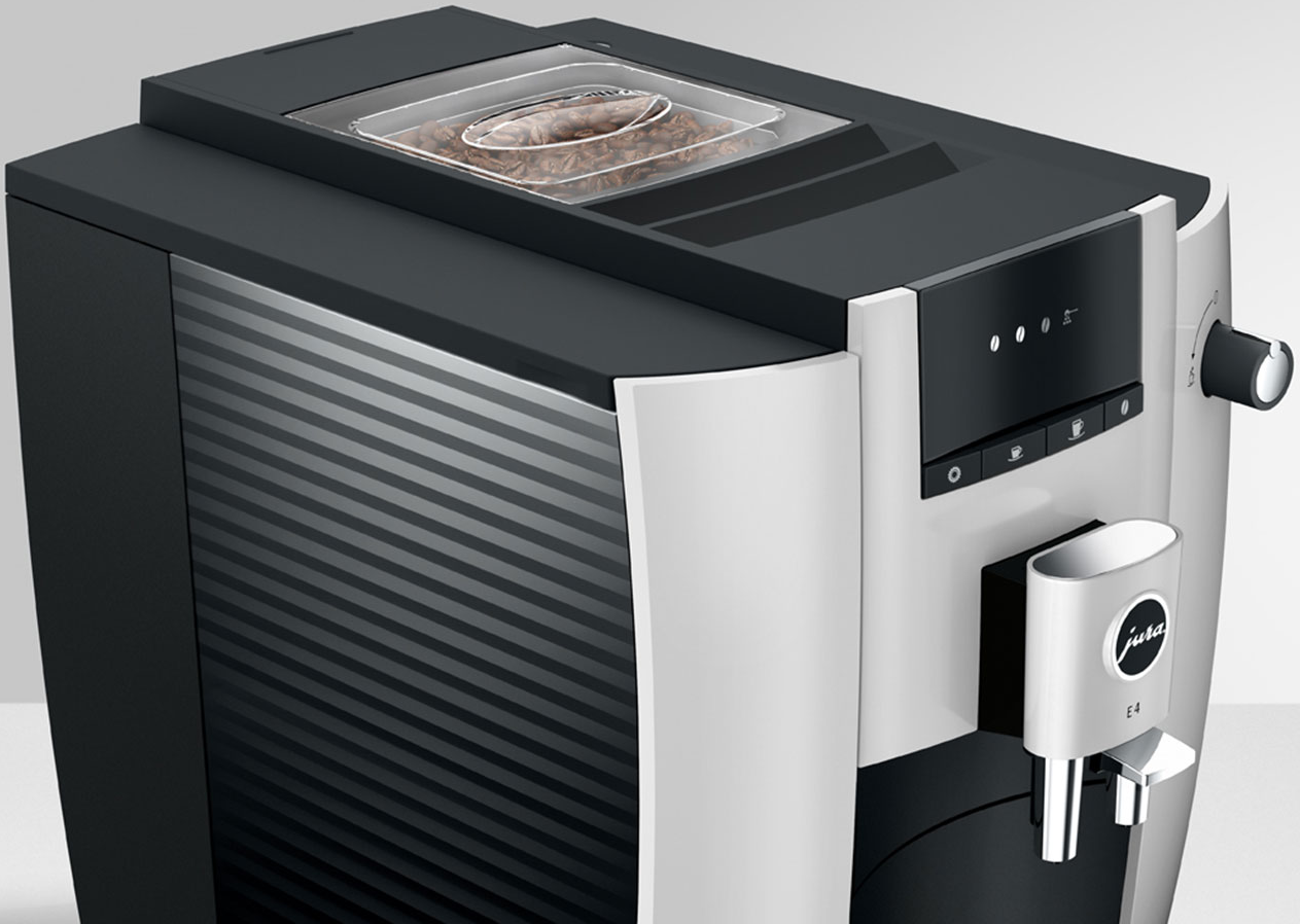 Una macchina per il caffè in bianco e nero con un contenitore trasparente per i chicchi sopra.