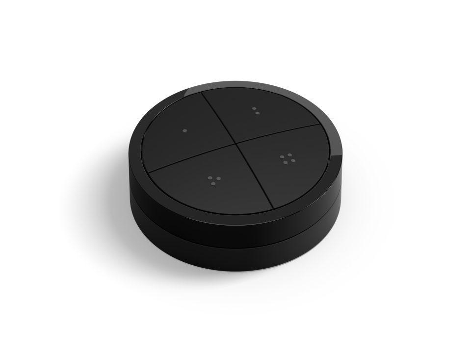 Ein schwarzer, runder Smart-Button mit vier unterteilten Bereichen. Jeder hat kleine Punkte.