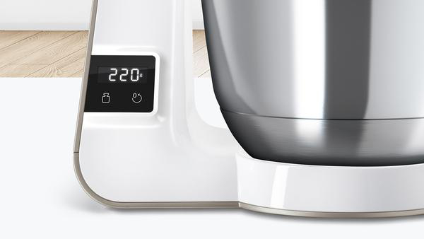 Nahaufnahme eines weißen Küchengeräts mit Digitalanzeige, die 220 Grad anzeigt.