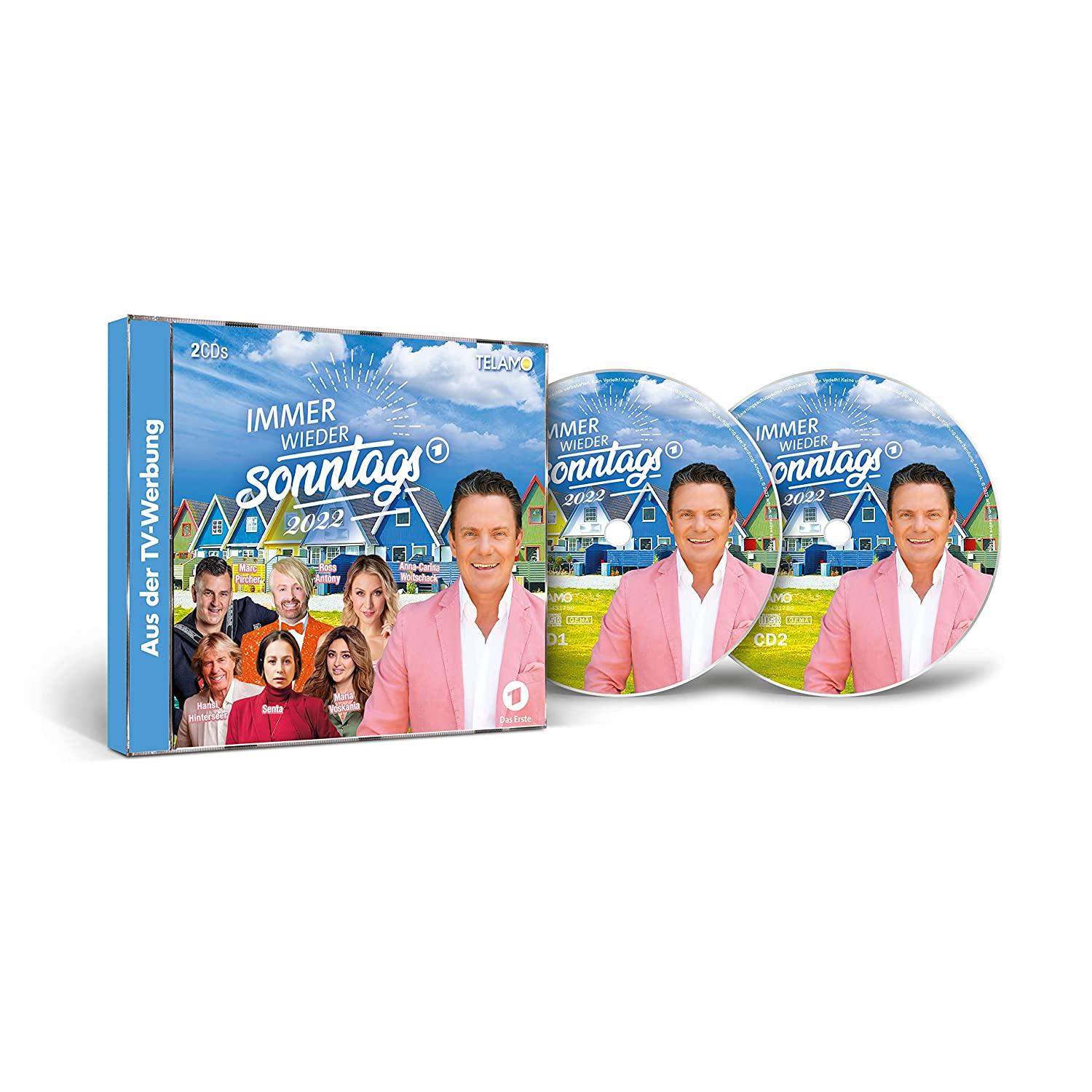 DVD-Set: Box und zwei Discs mit einem Mann in pinkem Blazer und einer Personengruppe.