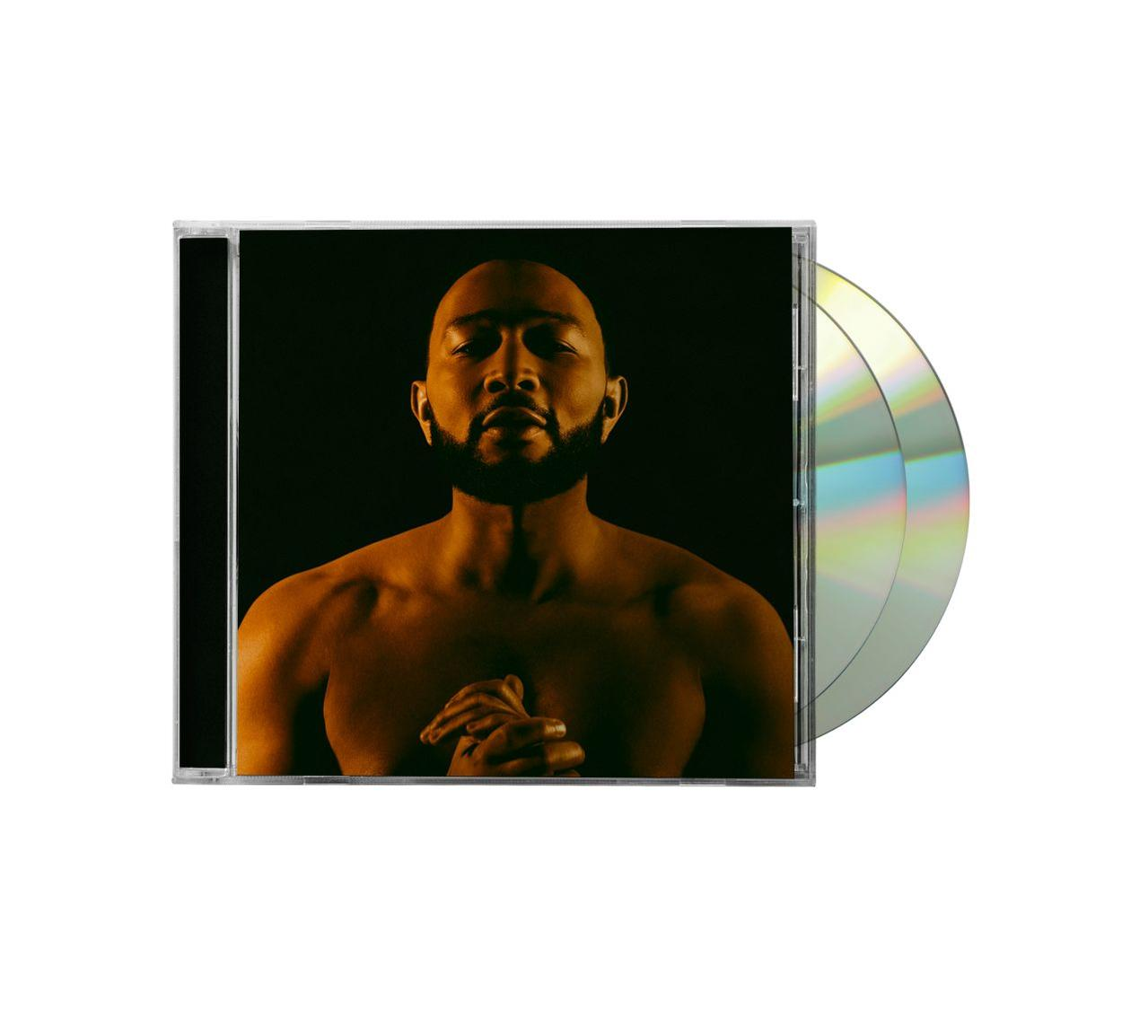 Un boîtier de CD avec John Legend sur la couverture. Deux CD sont visibles à côté du boîtier.