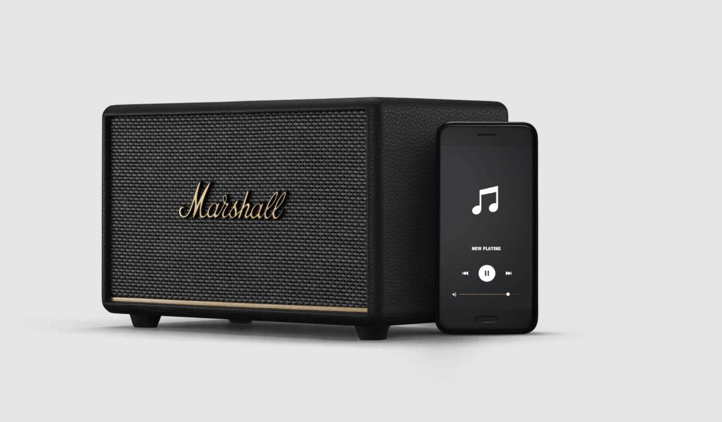 Schwarzer Marshall-Lautsprecher mit goldenem Logo und ein schwarzes Smartphone mit Musik-App.