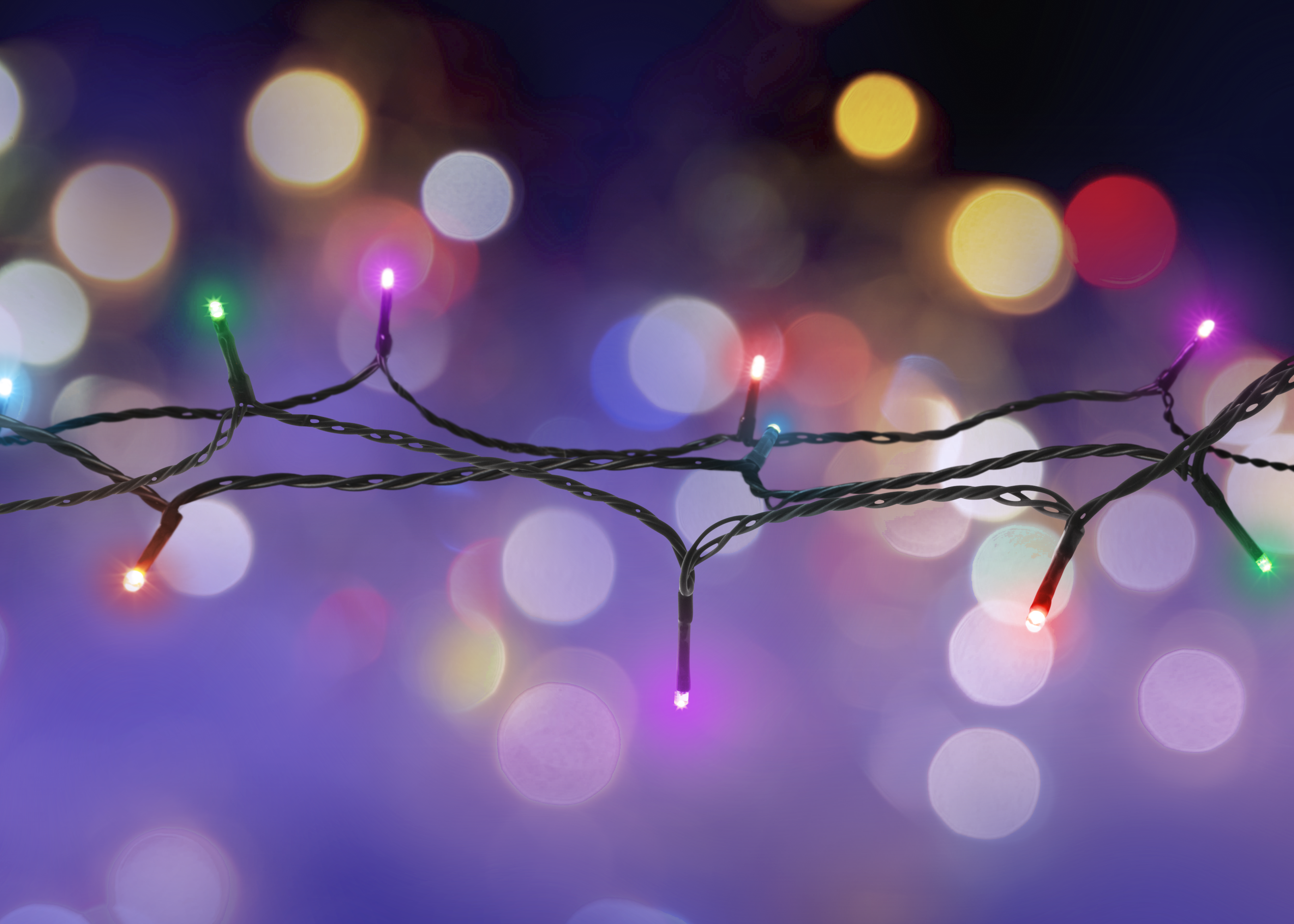 Lichterkette mit bunten Lichtern, verschwommener Hintergrund, festlich.