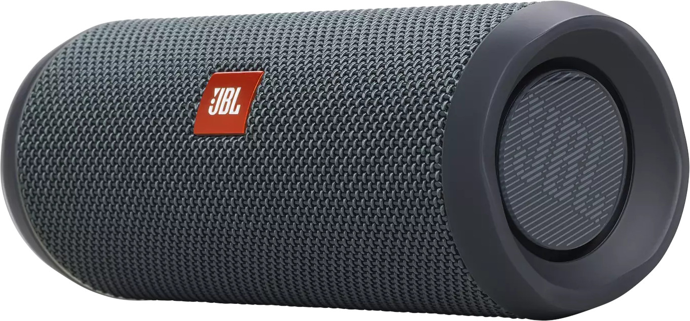 Un haut-parleur JBL cylindrique en gris foncé avec le logo JBL rouge sur une surface en maille grise.