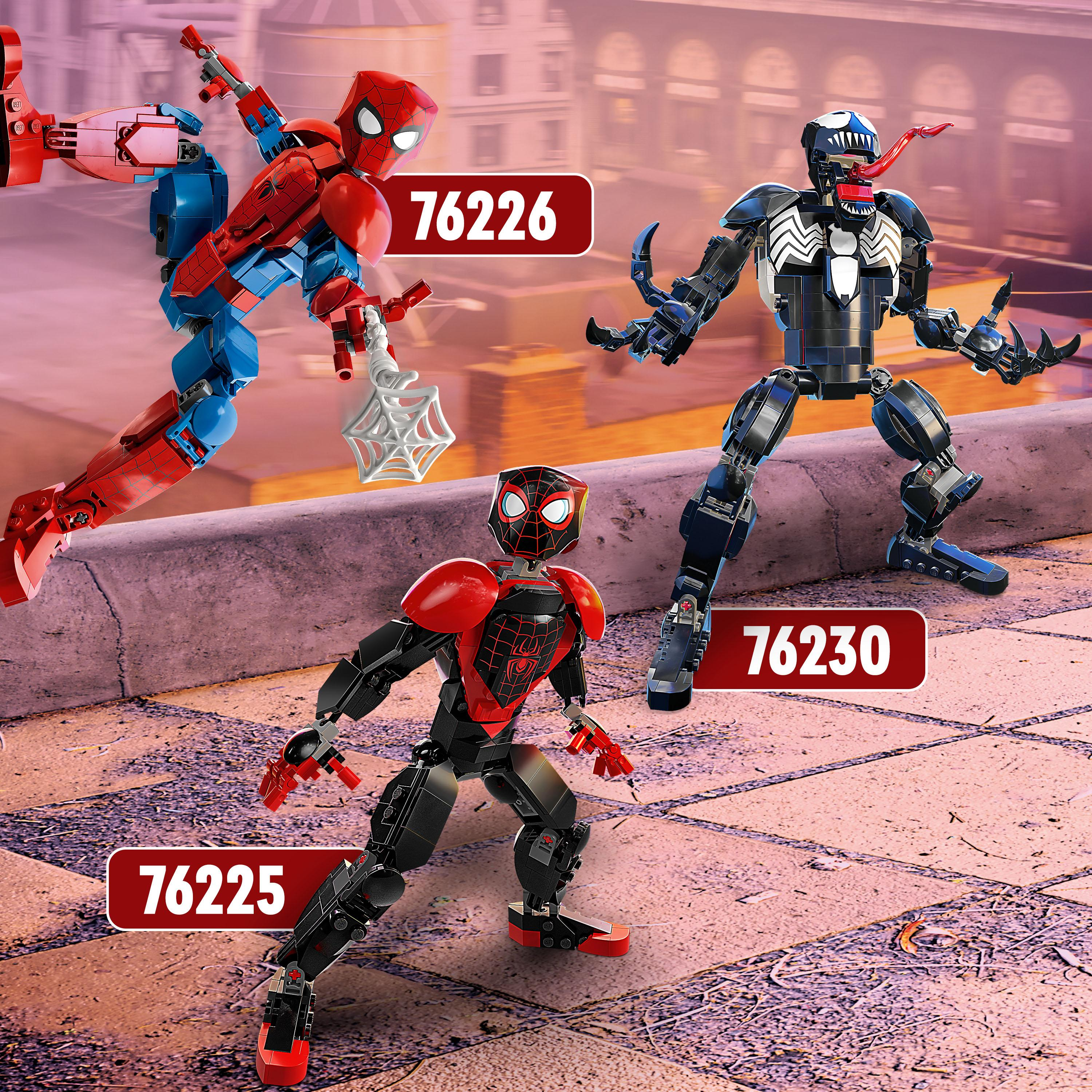 Drei Lego-Figuren von Spider-Man und Venom. Sie stehen auf einem Dach.