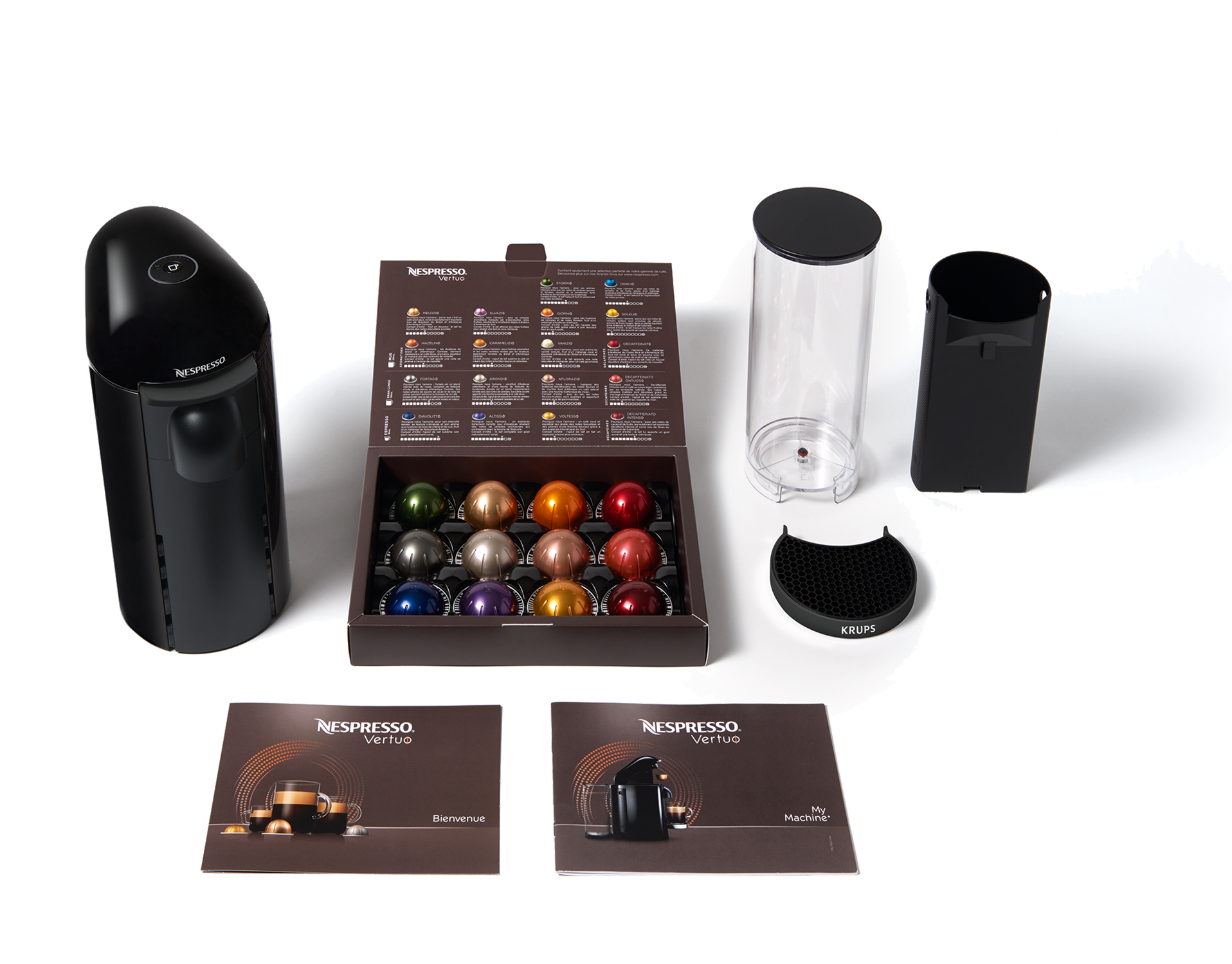 Nespresso machine and accessories: capsules, cups, and a descaling kit.