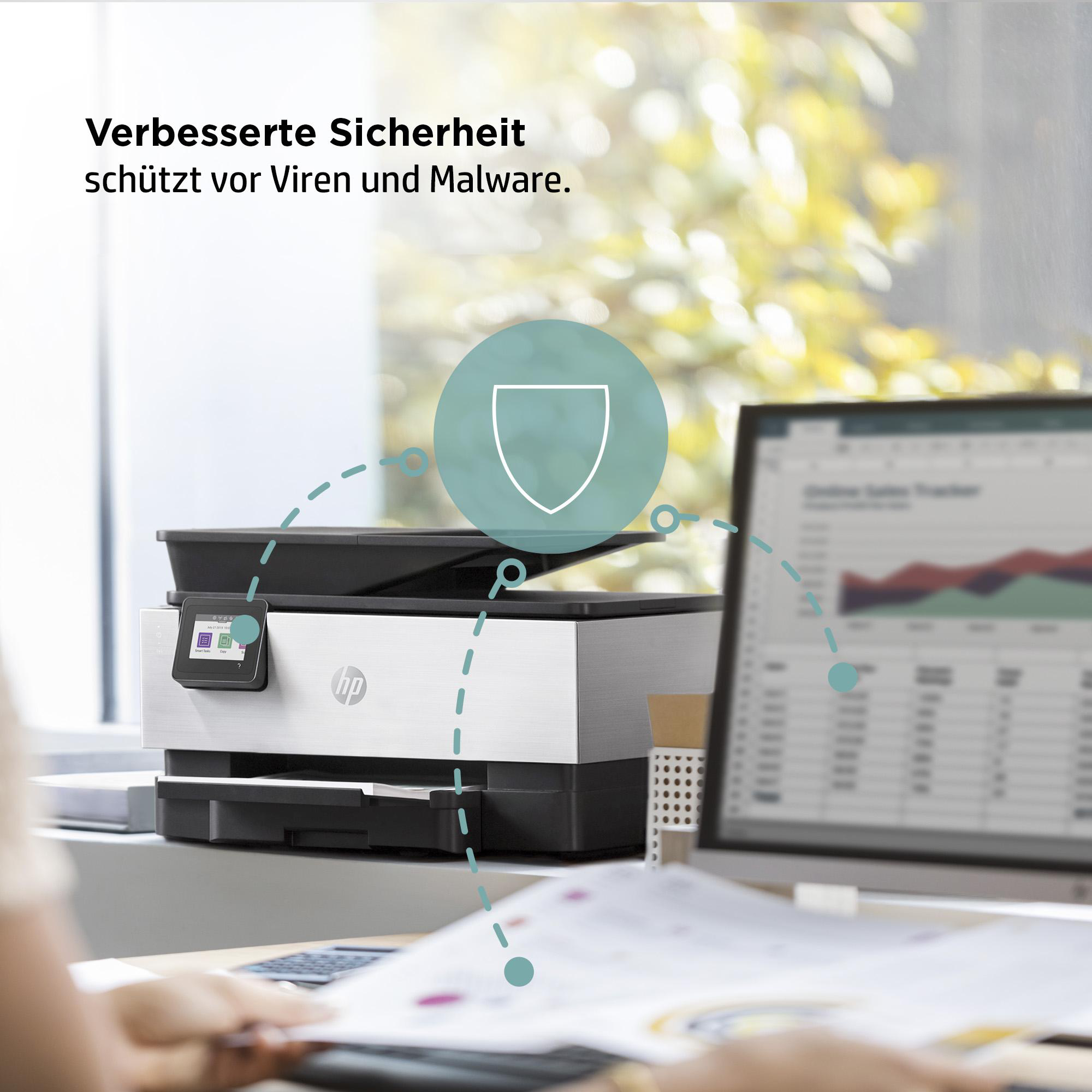 Drucker auf einem Schreibtisch mit Computer und dem Text 'Verbesserte Sicherheit'.