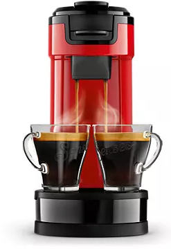 Rode koffiemachine met twee kopjes. Stoom komt uit de kopjes. De machine is zwart en rood.