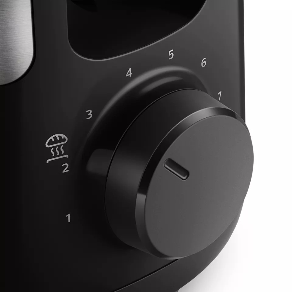 A close-up view of a black toaster's control panel, with a dial and settings.