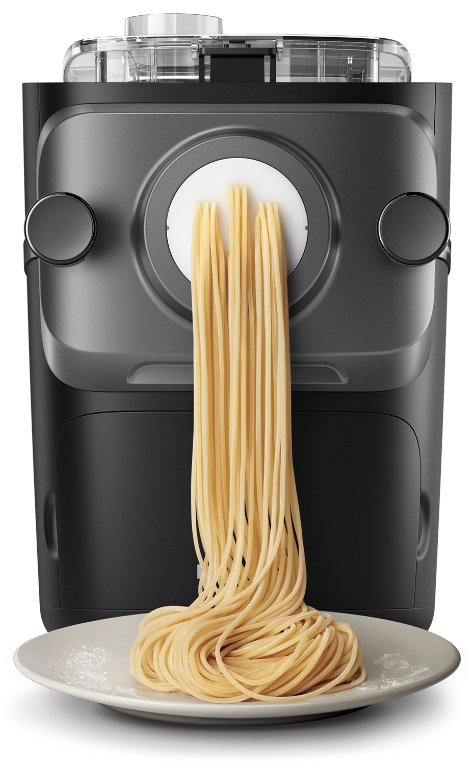 A pasta maker extrudes spaghetti onto a plate. The machine and spaghetti are dark against a black backdrop.