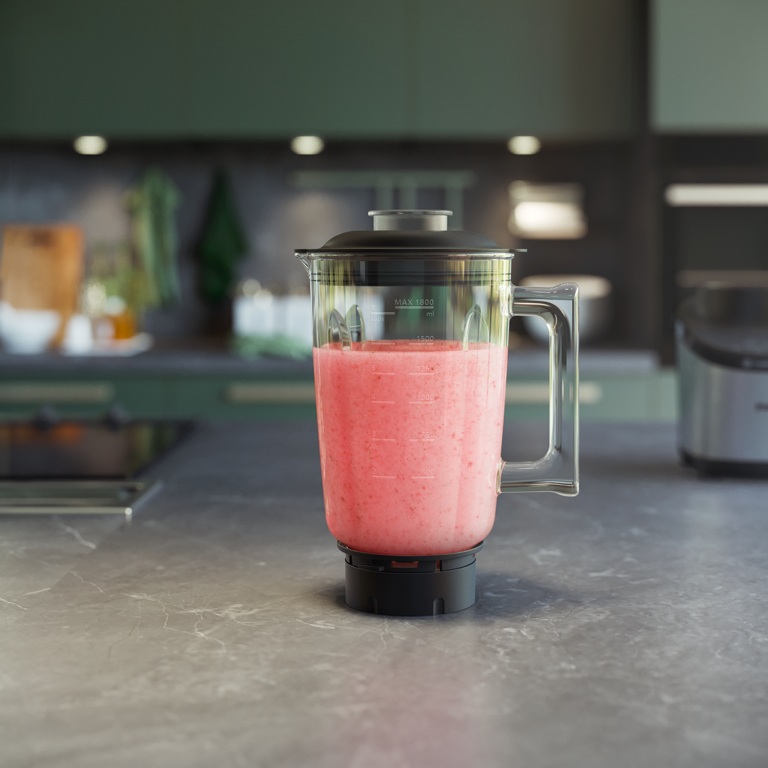 Blender with pink smoothie inside, on a countertop with a green kitchen in the background.