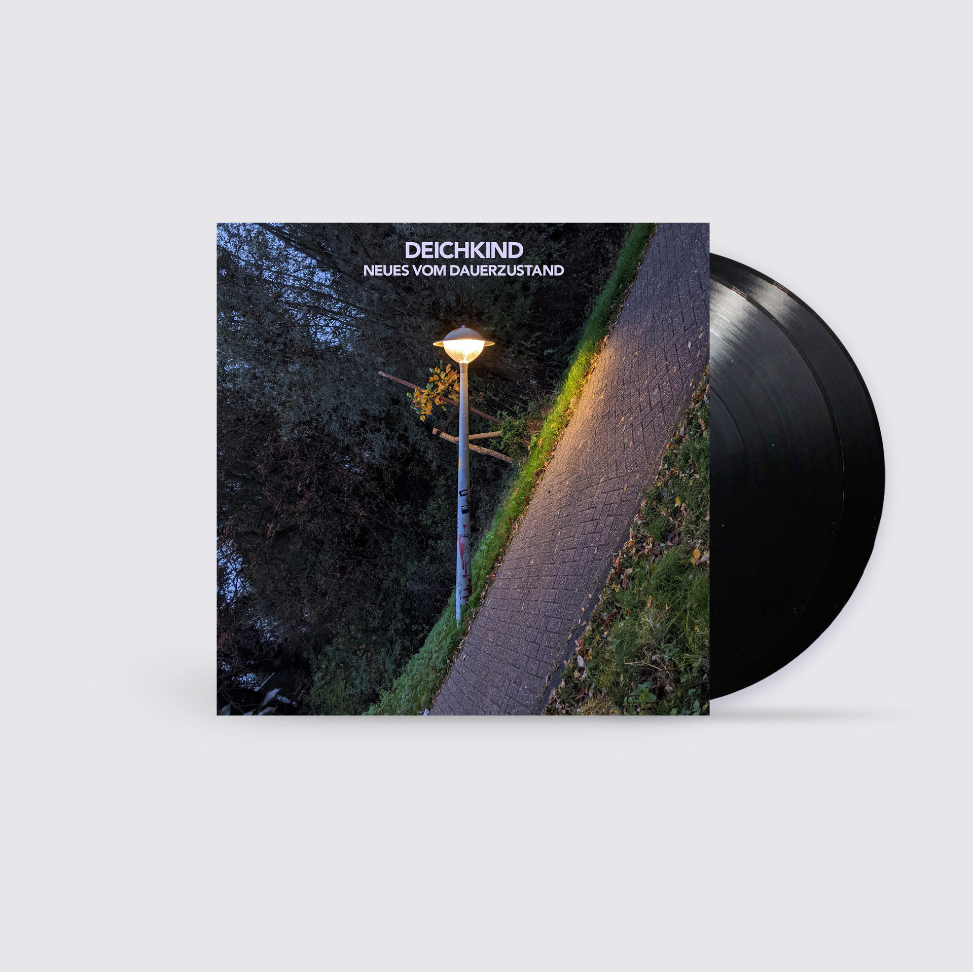 Ein Vinyl-Schallplatten-Albumcover mit einer Straßenlaterne und einem Weg. Die Platte ist rechts.