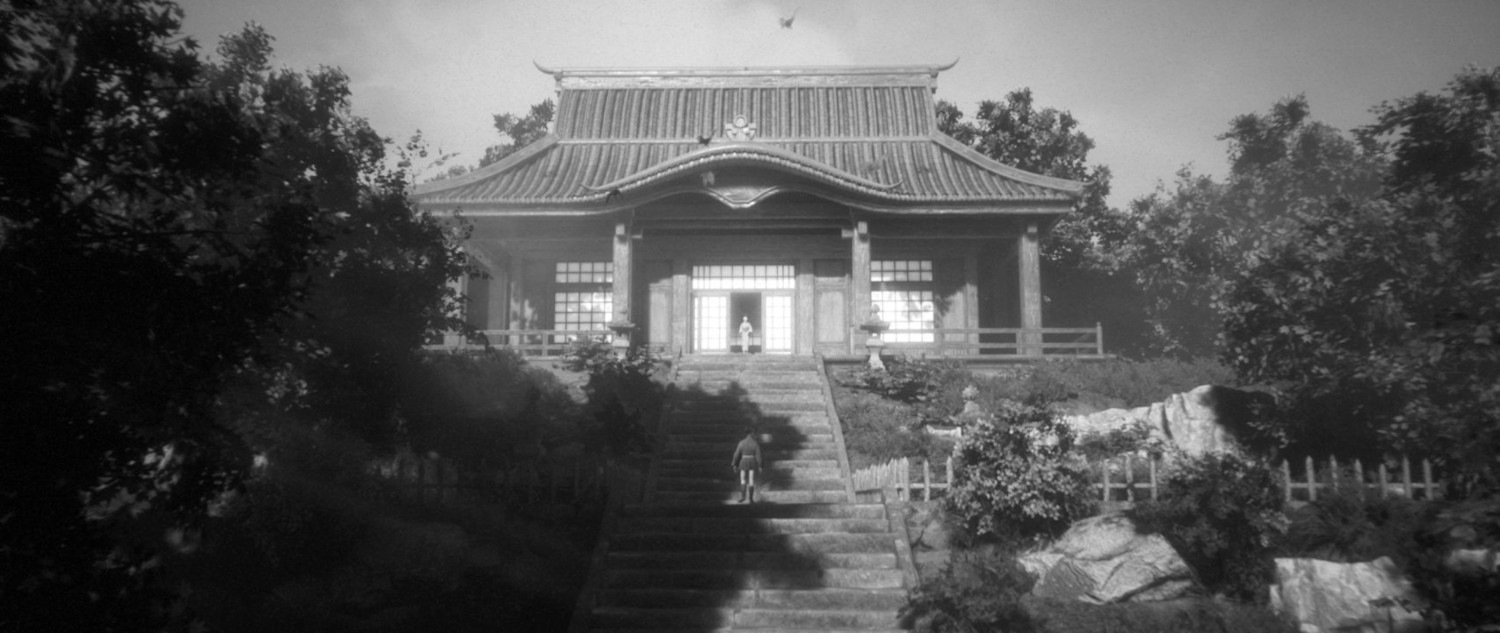 Zwart-wit afbeelding van een Japanse tempel met trappen die ernaartoe leiden.