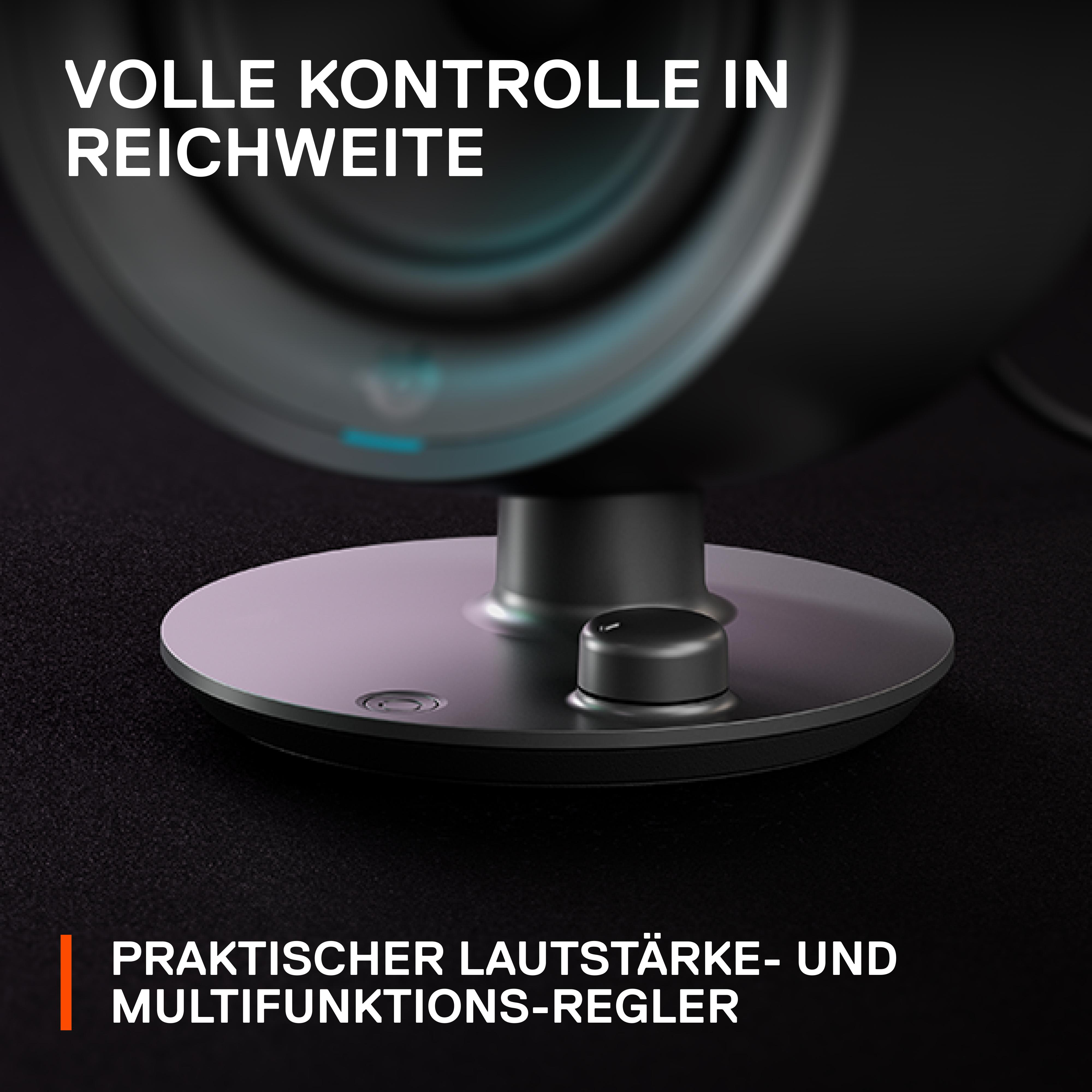 Nahaufnahme eines schwarzen Lautsprecherfußes mit einem Drehregler und einem kleinen Licht.