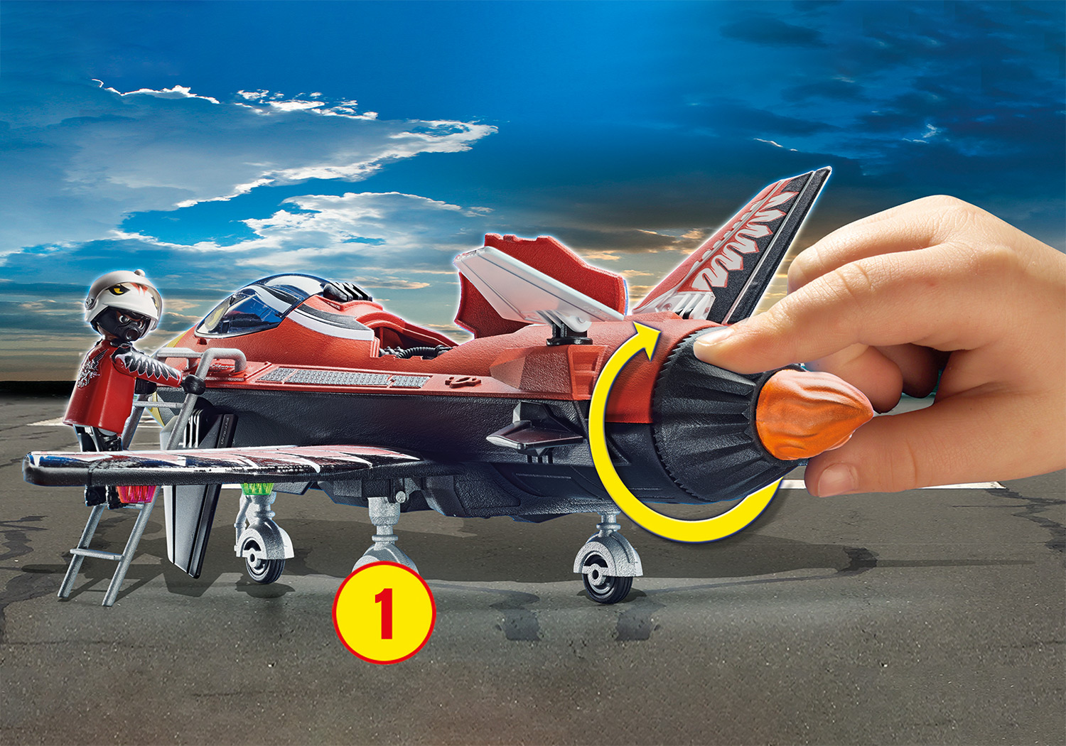 Playmobil-Jet mit Person. Rote und schwarze Farben, auf einer Startbahn. Person, die das Heck des Jets einstellt.
