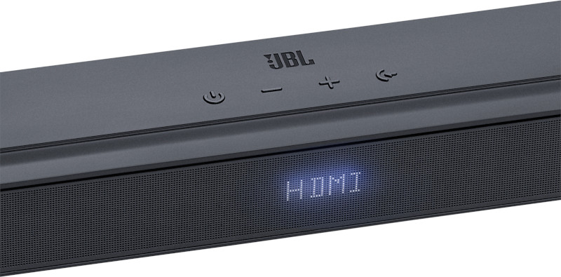 Une barre de son noire avec le mot 'HDMI' affiché à l'avant. Boutons sur le dessus.
