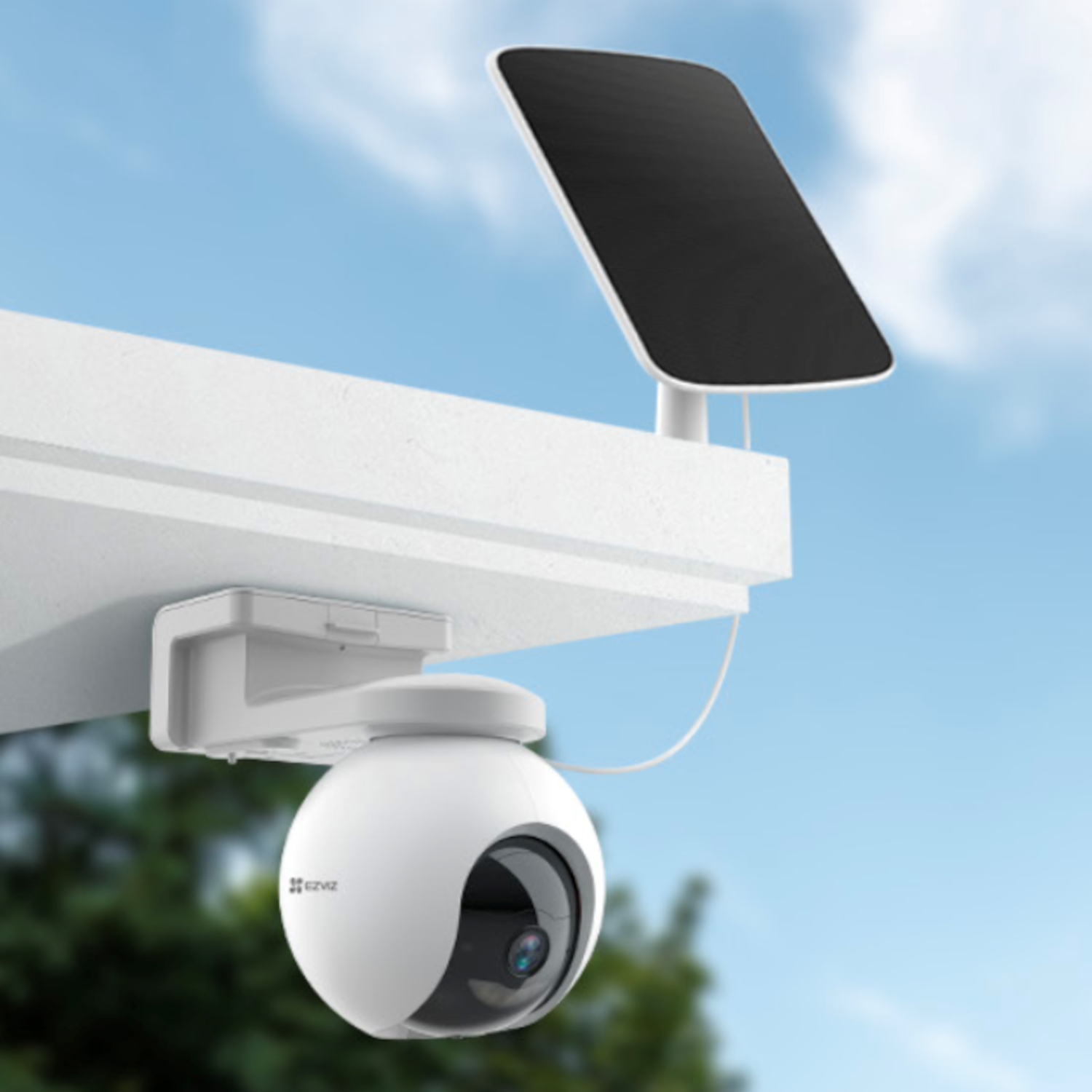 White security camera with solar panel on a wall, blue sky in the background.