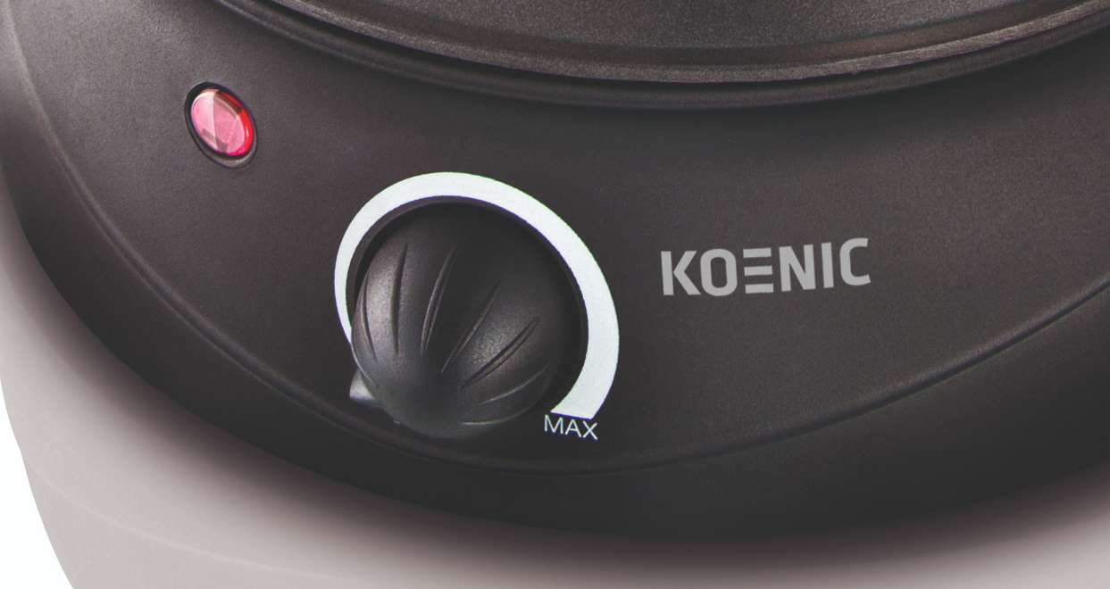 Közelkép egy Koenic készülékről, tárcsával és a 'KOENIC' logóval.