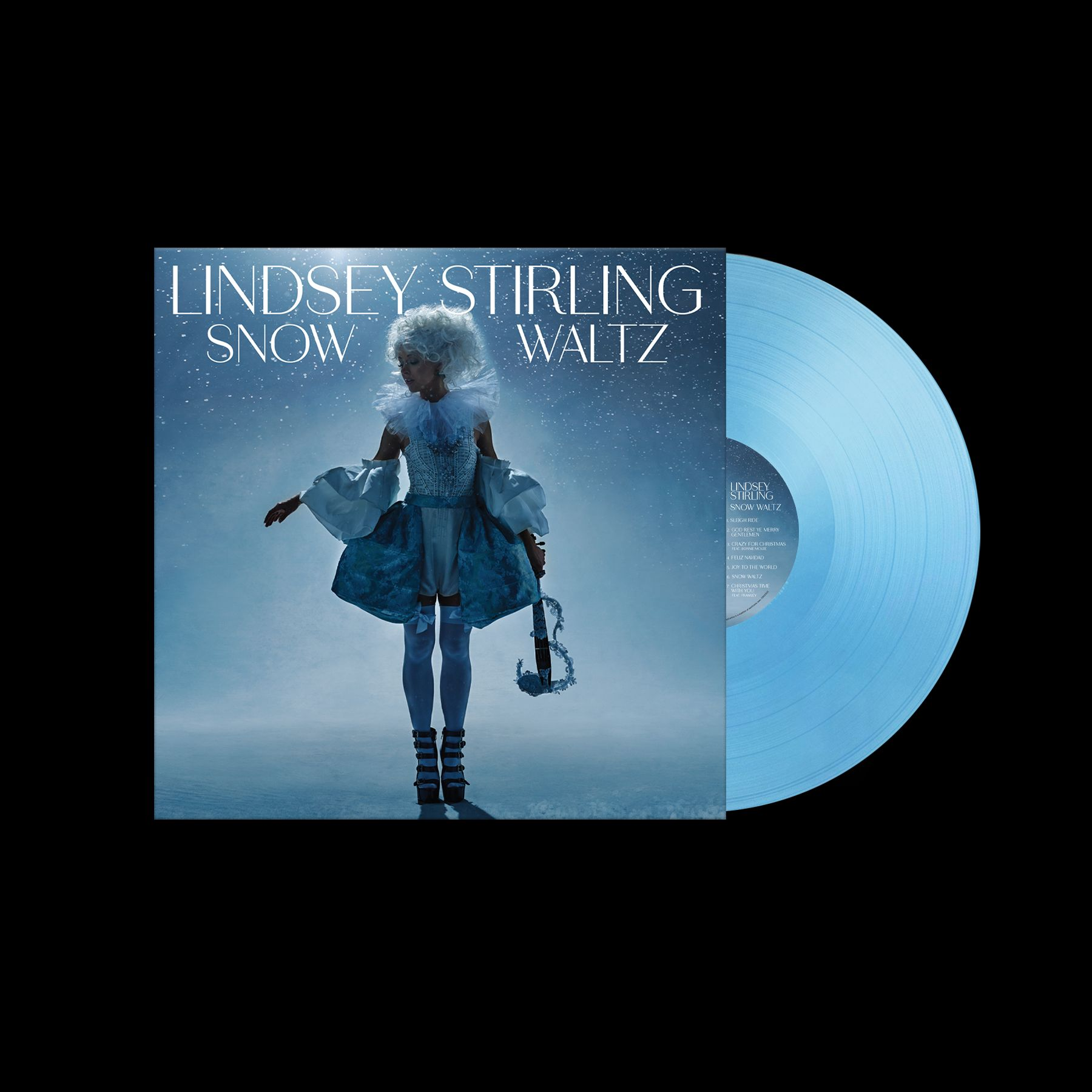 Albumcover: Lindsey Stirling 'Snow Waltz' mit einer blauen Schallplatte daneben. Eine Frau steht in einer schneebedeckten Szene.