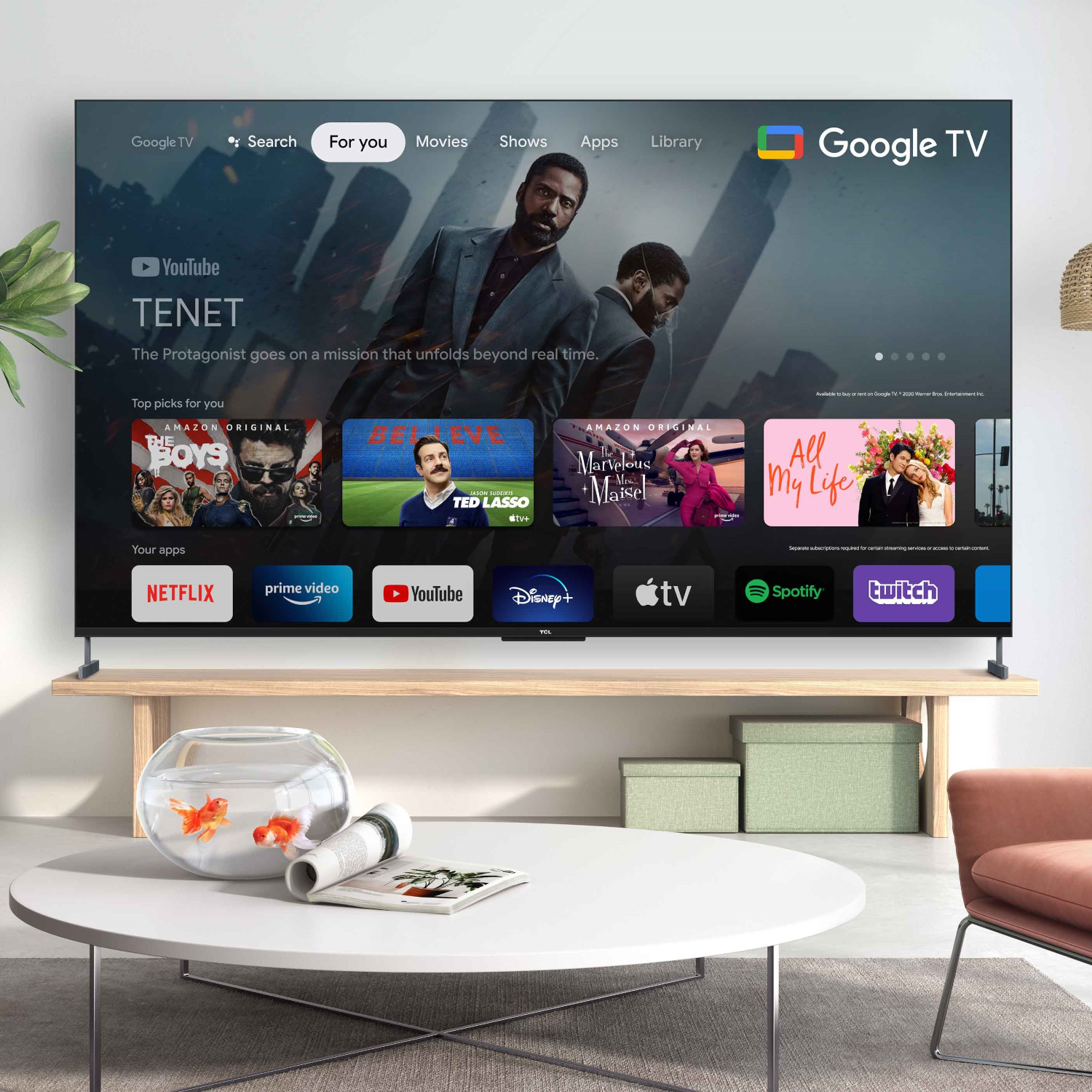 Large TV displaying a movie scene, with apps and additional content on a wooden table.