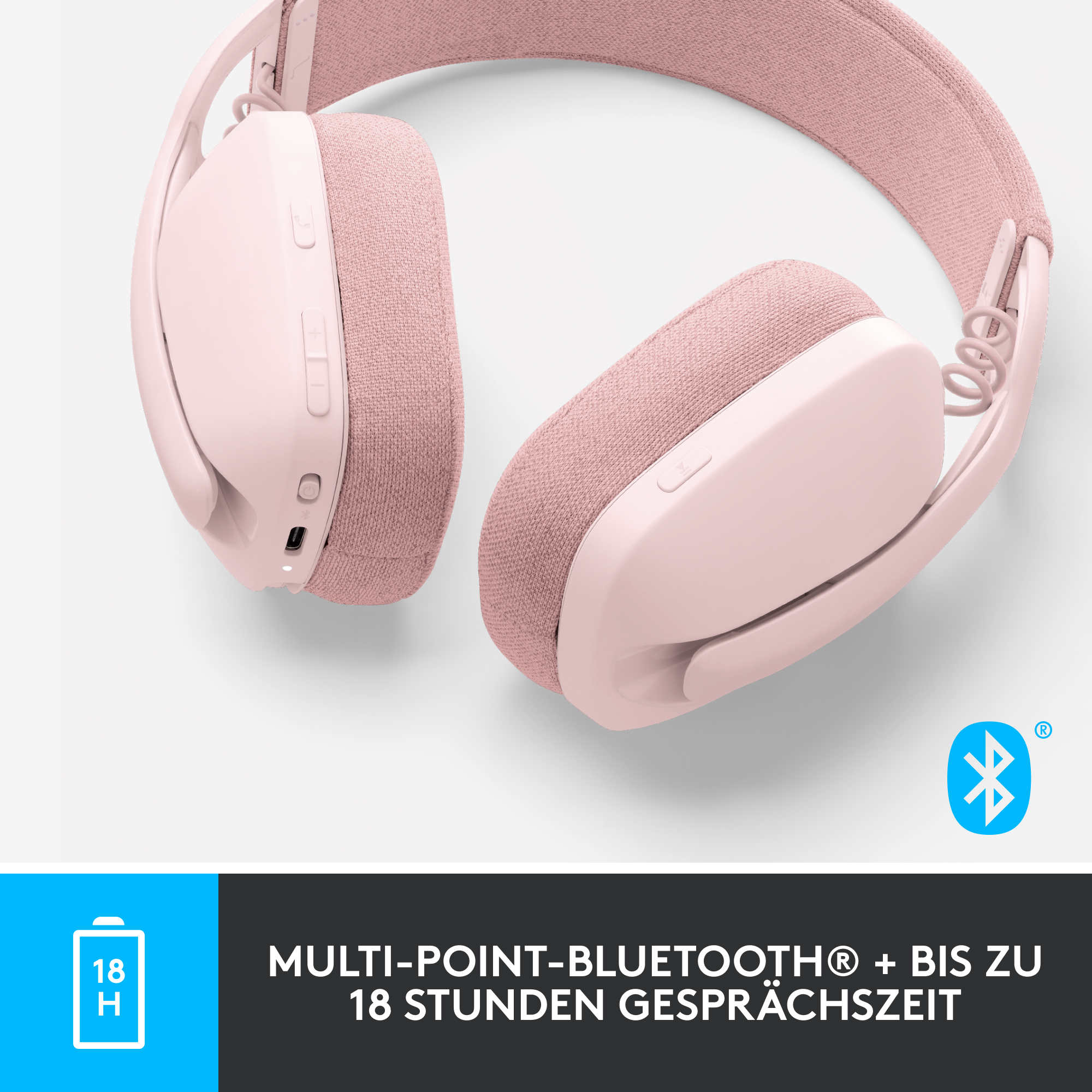 Rosa Kopfhörer, Nahaufnahme auf weißem Hintergrund, mit Batteriesymbol.