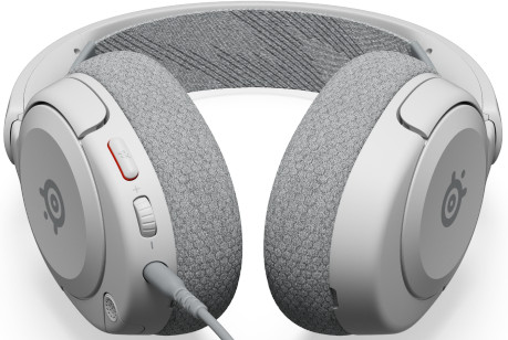 Casque blanc avec coussinets gris et câble. Commandes de volume visibles d'un côté.