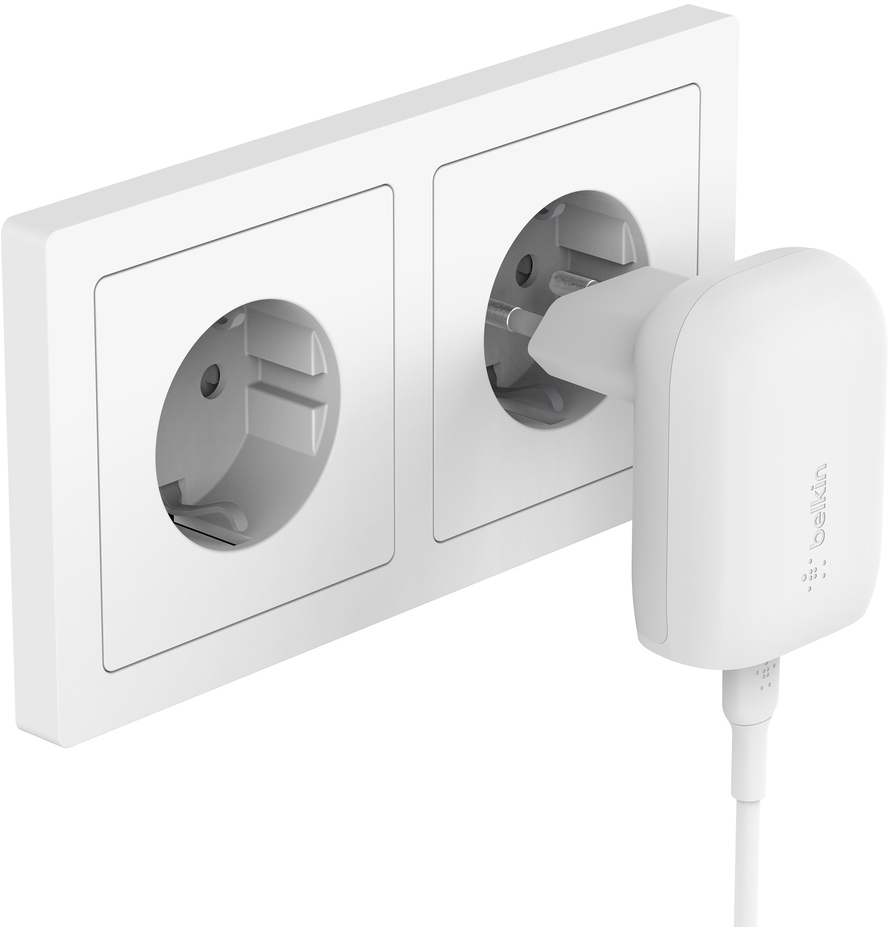 White wall outlet with a plugged-in white Belkin charger.
