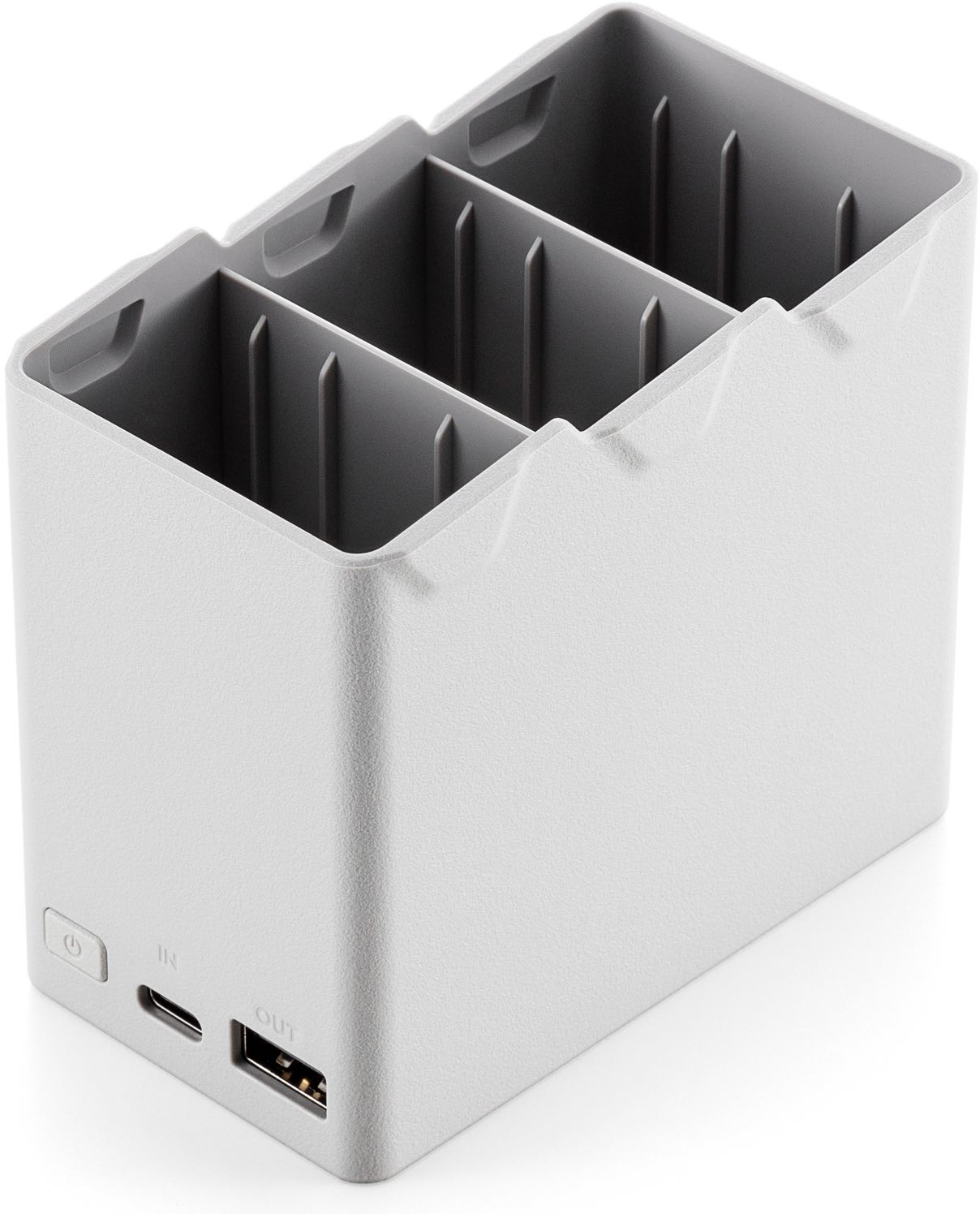 A light gray multi-device charger with three slots and a few ports.