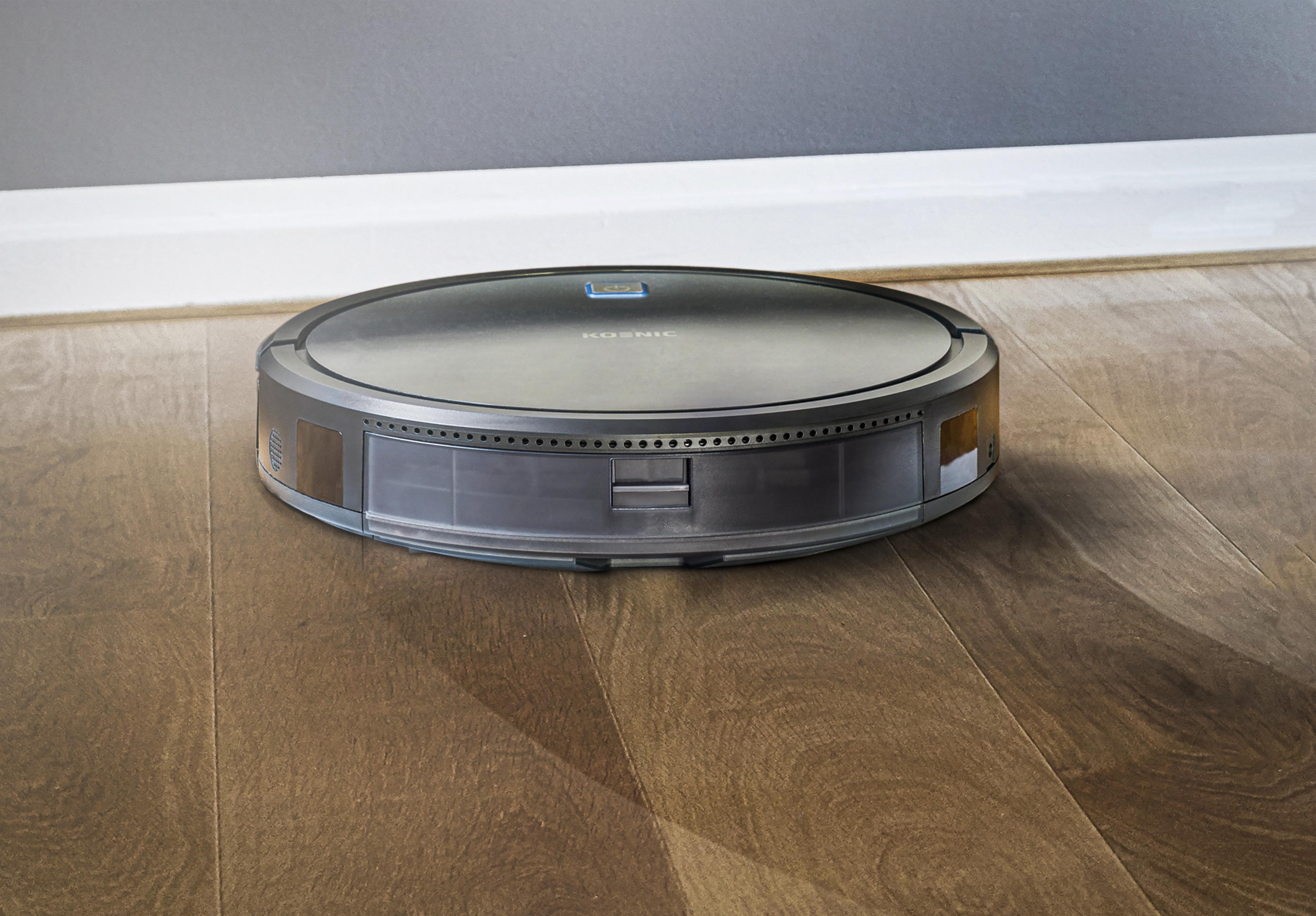 Roboter-Staubsauger auf einem Holzboden. Der Reiniger ist silber und schwarz, mit dunklem Rand.