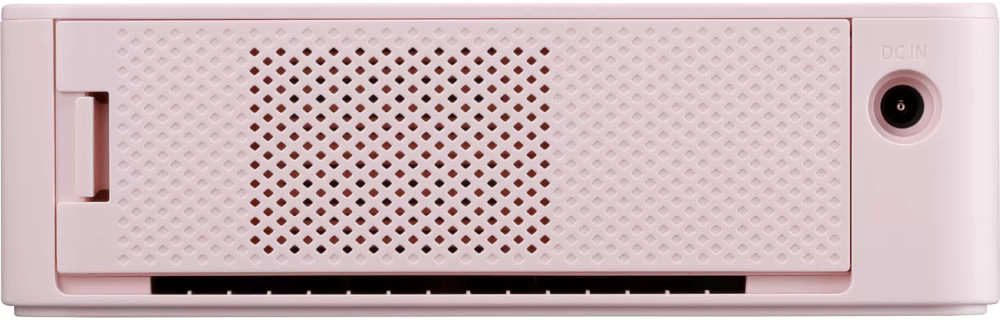 Close-up of a pink device. It has a grid design and a DC IN port.