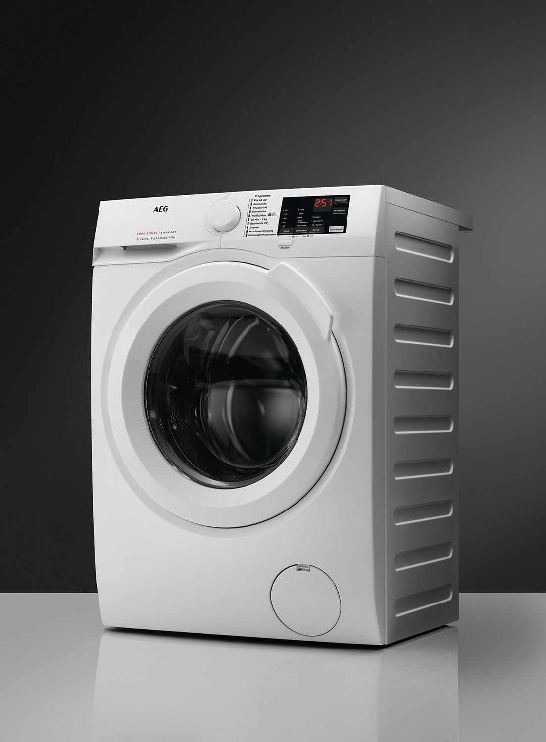A white AEG washing machine against a dark grey background.