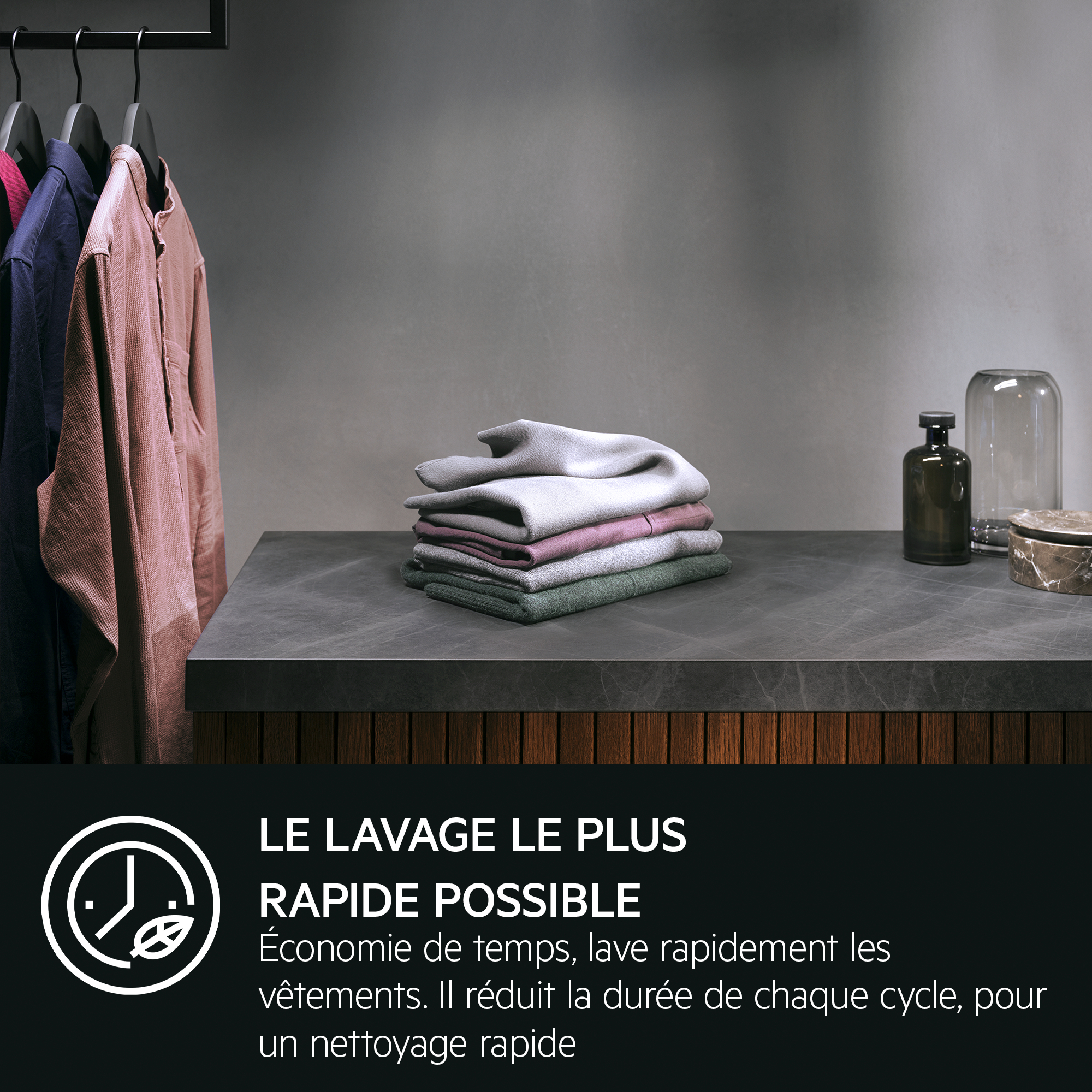 Clothes hang on hangers, with stacked clothes and decor nearby.