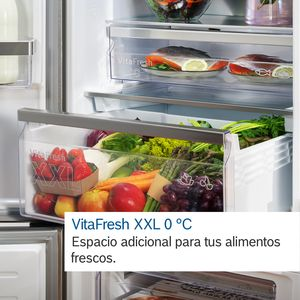 Un cajón abierto de un frigorífico lleno de productos frescos, etiquetado como 'VitaFresh XXL 0°C'.