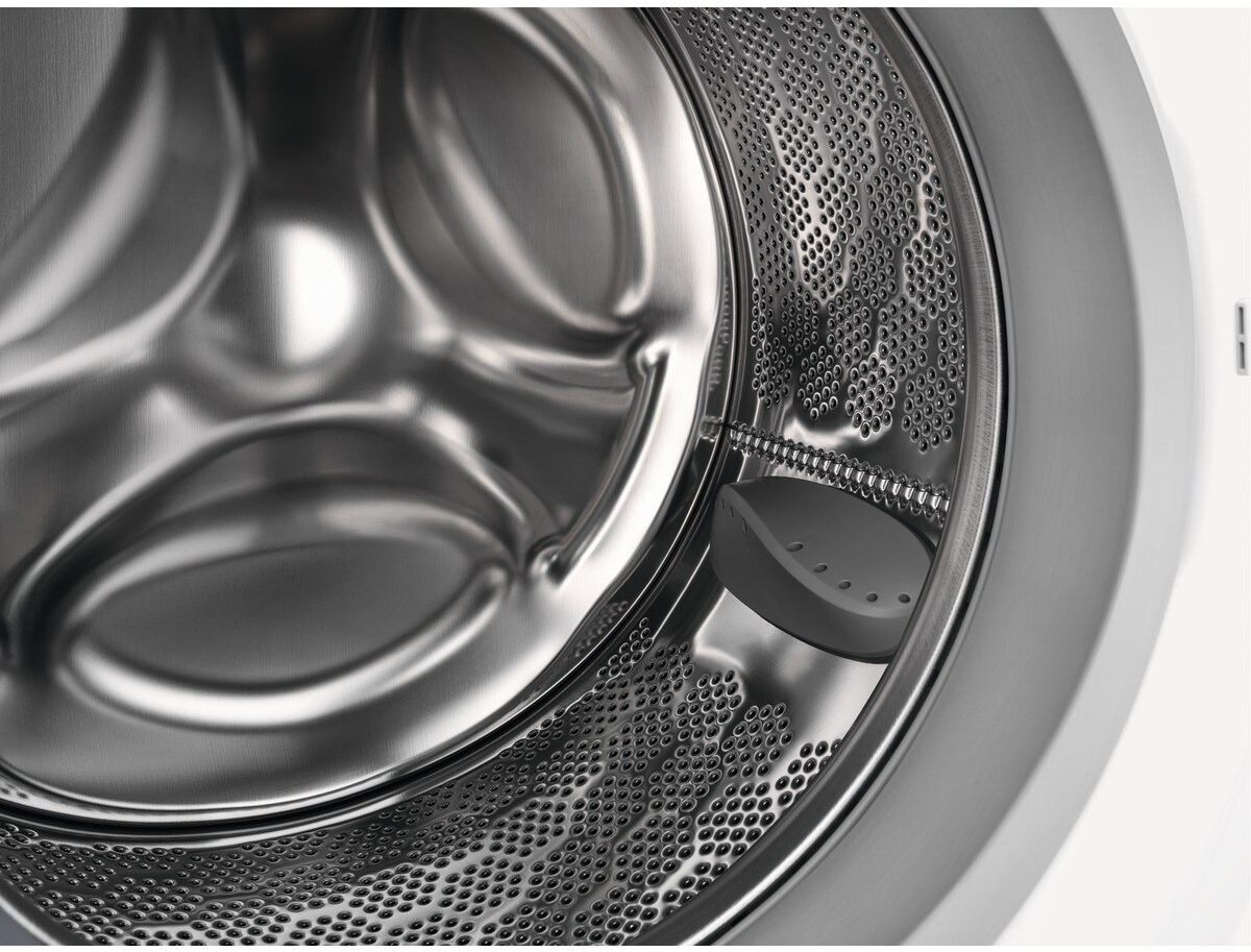 Washing machine drum interior, stainless steel, close-up view.