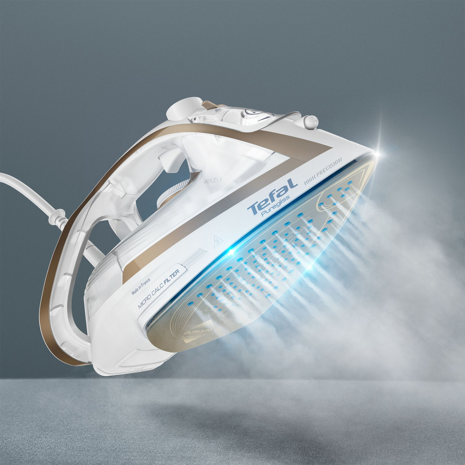 White and gold iron emitting steam. The Tefal logo is visible.
