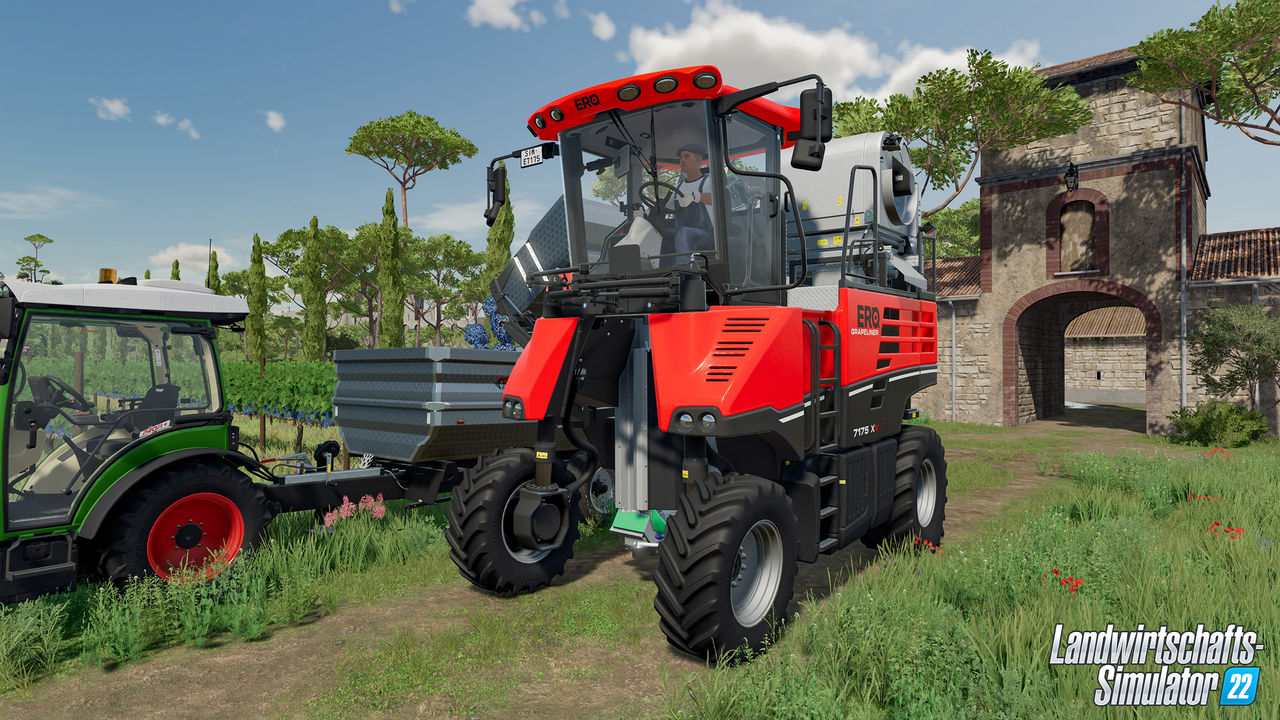 Rote und schwarze Landmaschine auf einem Feld, mit einem Traktor.