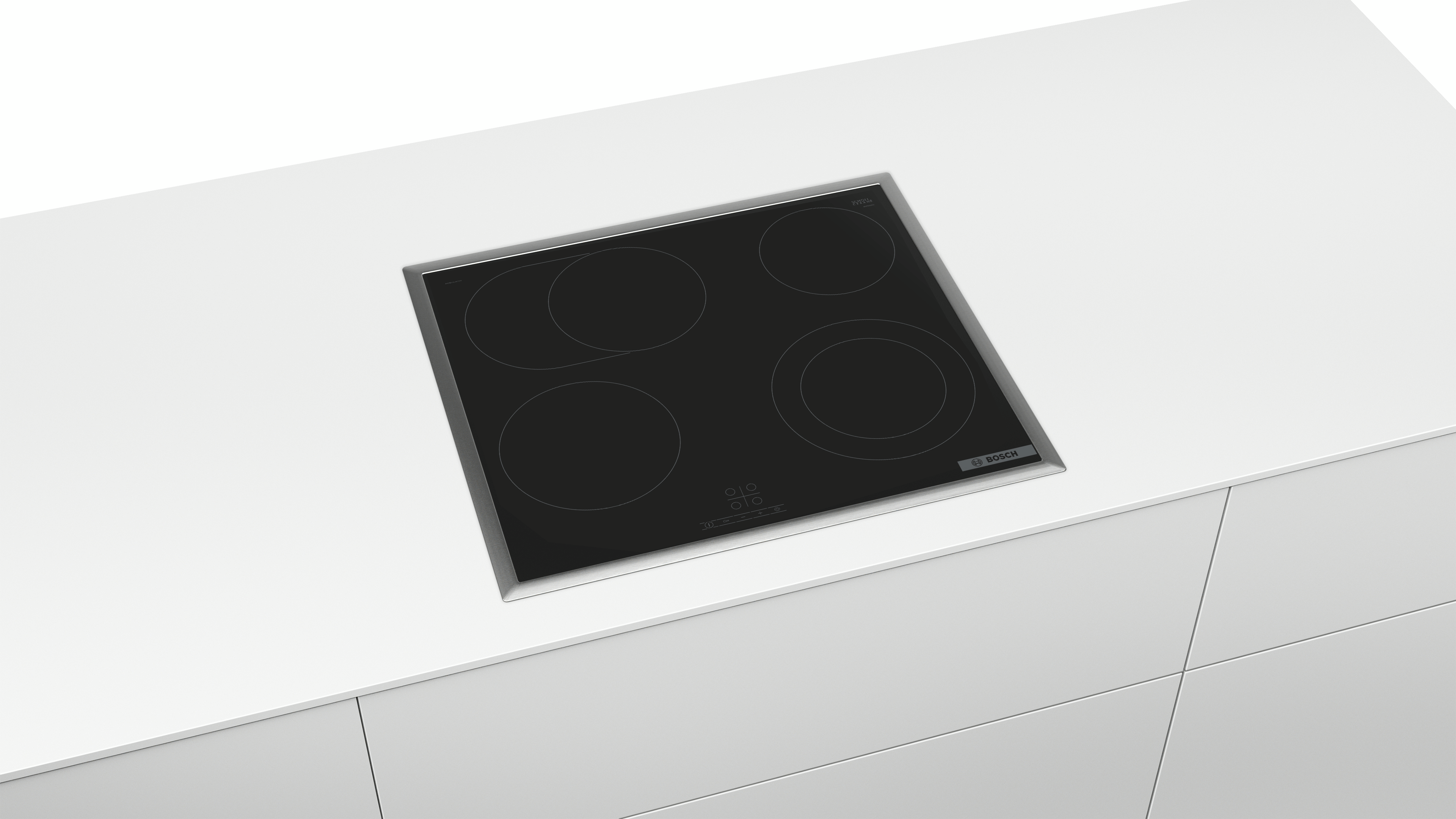 Ein schwarzes, eingebautes elektrisches Kochfeld mit vier kreisförmigen Kochfeldern auf einer weißen Arbeitsplatte.