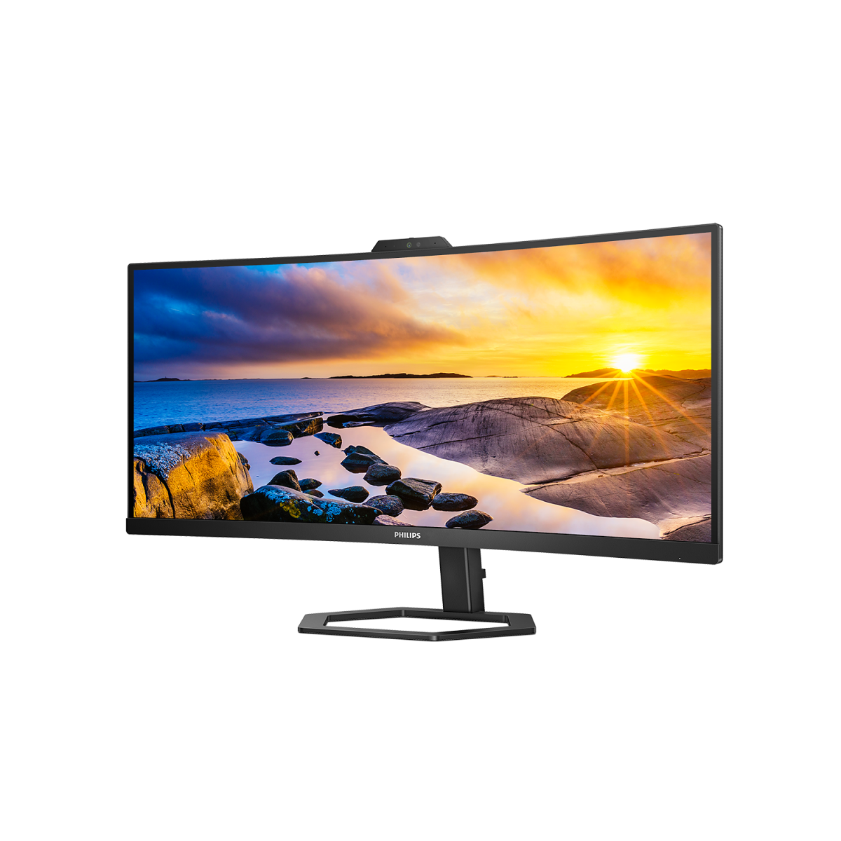 Ein gebogener Monitor mit einer Sonnenuntergangsszene. Der Monitor steht auf einem schwarzen Ständer.