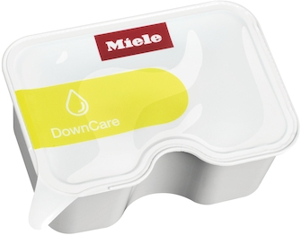 A white Miele DownCare product container. Yellow label is visible.
