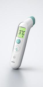 Ein weißes digitales Thermometer zeigt 37,0°C an. Es liegt auf einer weißen Oberfläche und hat eine grüne Taste.