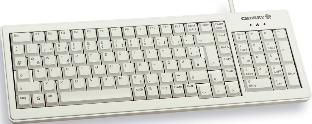Eine cremefarbene Cherry-Tastatur mit verschiedenen Tasten, einschließlich Funktionstasten, Buchstaben, Zahlen und einem Ziffernblock.