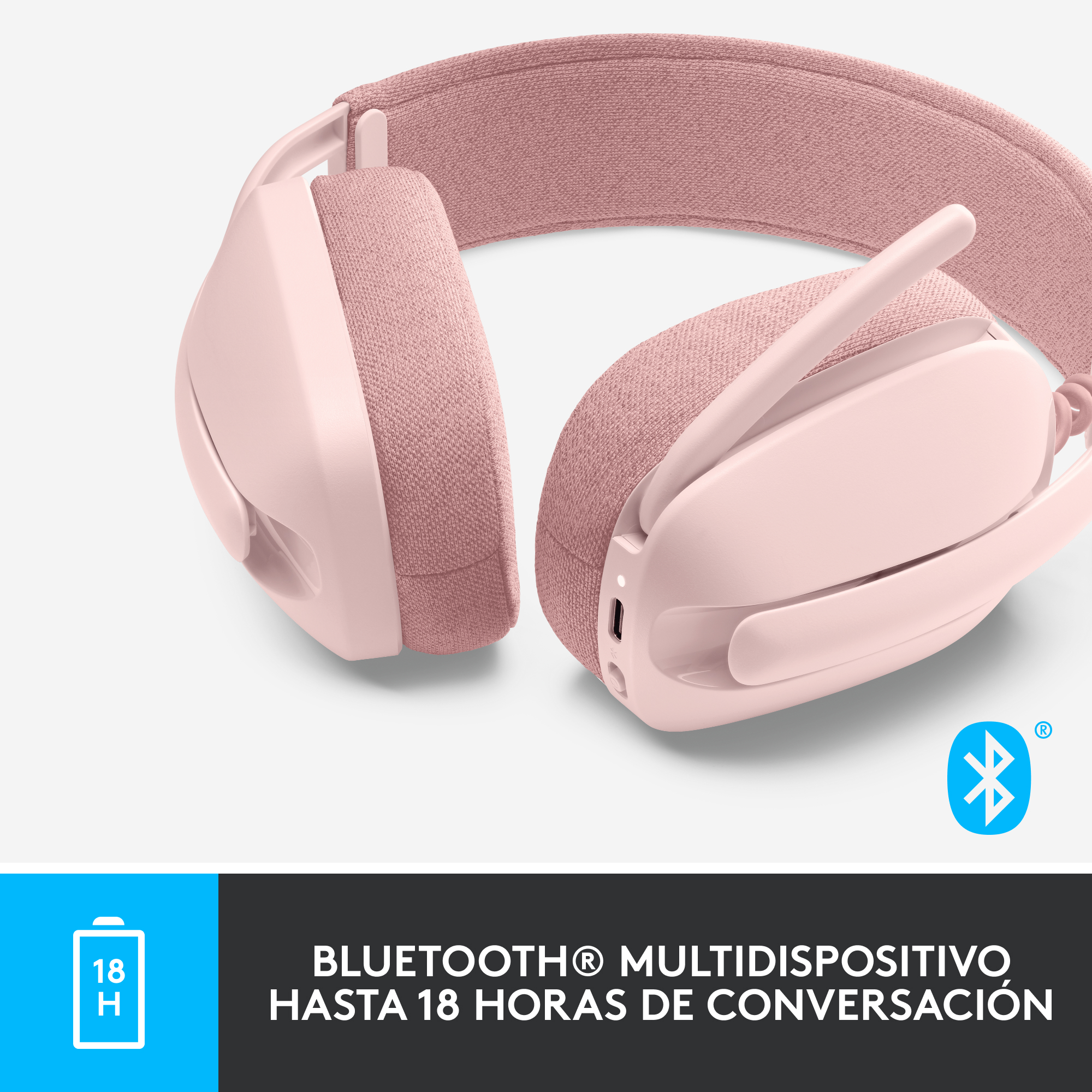 Auriculares rosas con micrófono y símbolo Bluetooth sobre una superficie blanca.