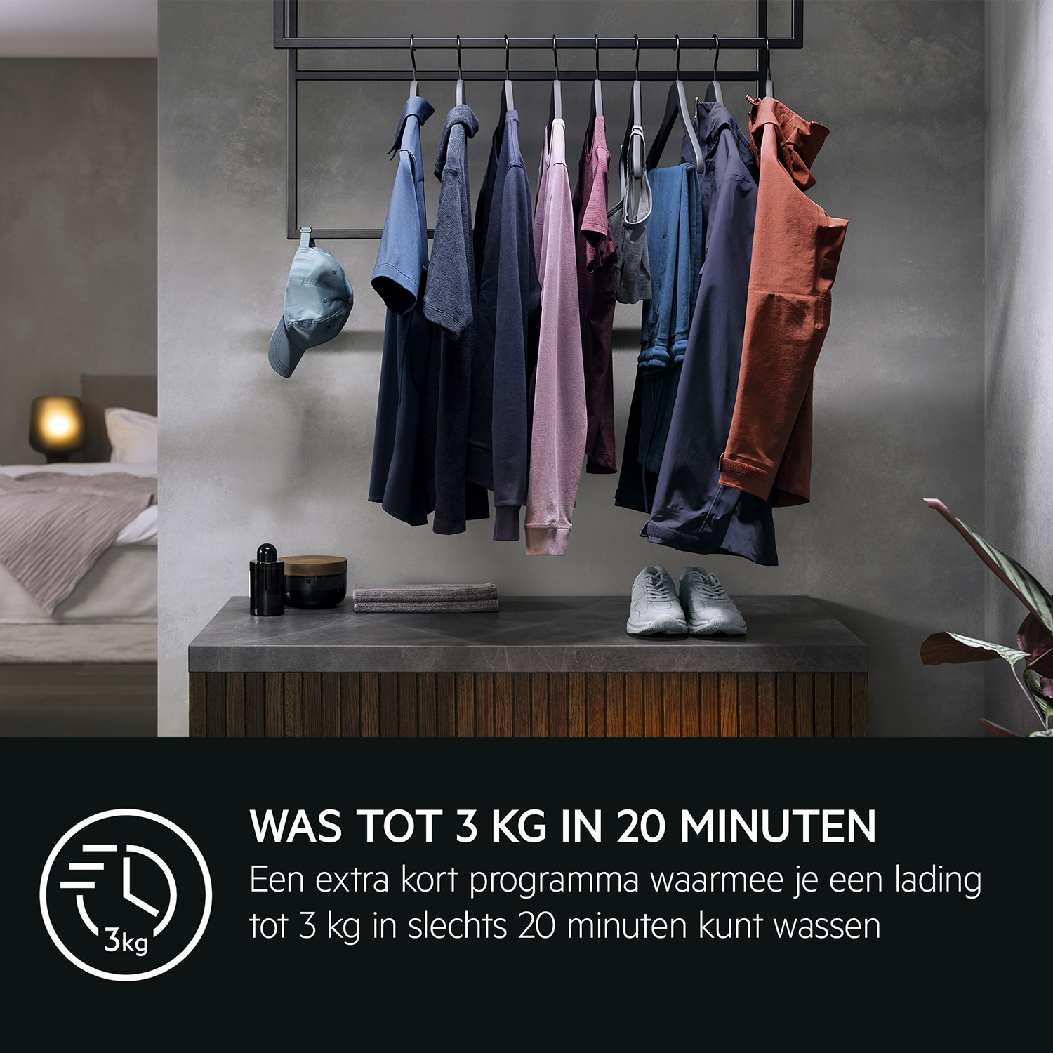 A bedroom with clothes hanging on a rack, a bed, and a small table.