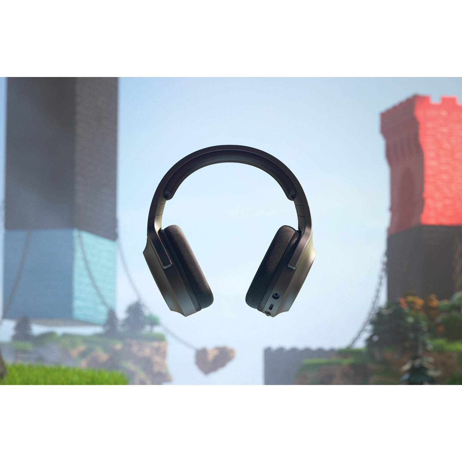 Auriculares negros flotando en el aire. El fondo muestra un castillo y el cielo.
